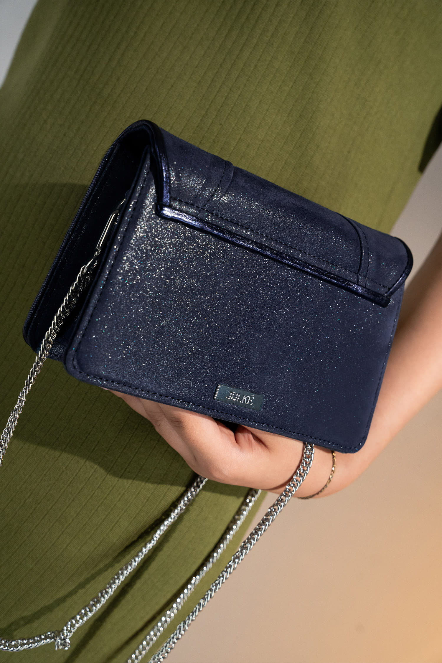 Womens leather shoulder clutch bag in dark blue colour with satin piping and rhinestone brooch by JULKE.