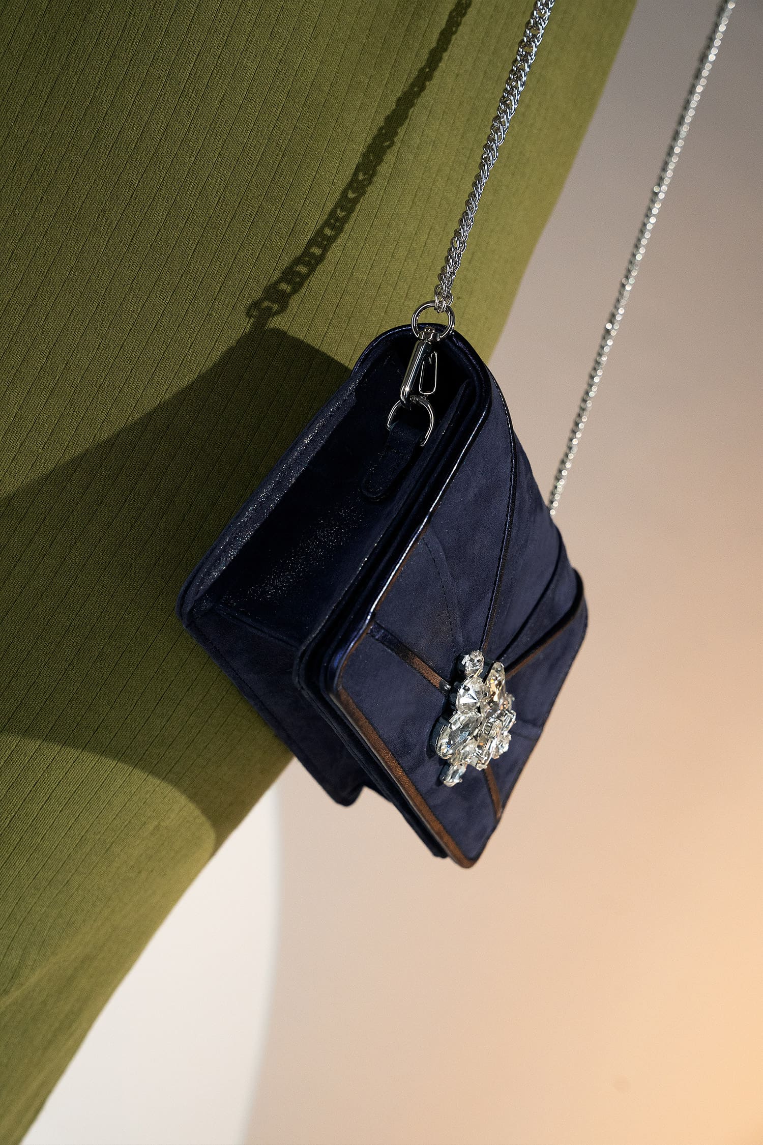 Womens leather shoulder clutch bag in dark blue colour with satin piping and rhinestone brooch by JULKE.
