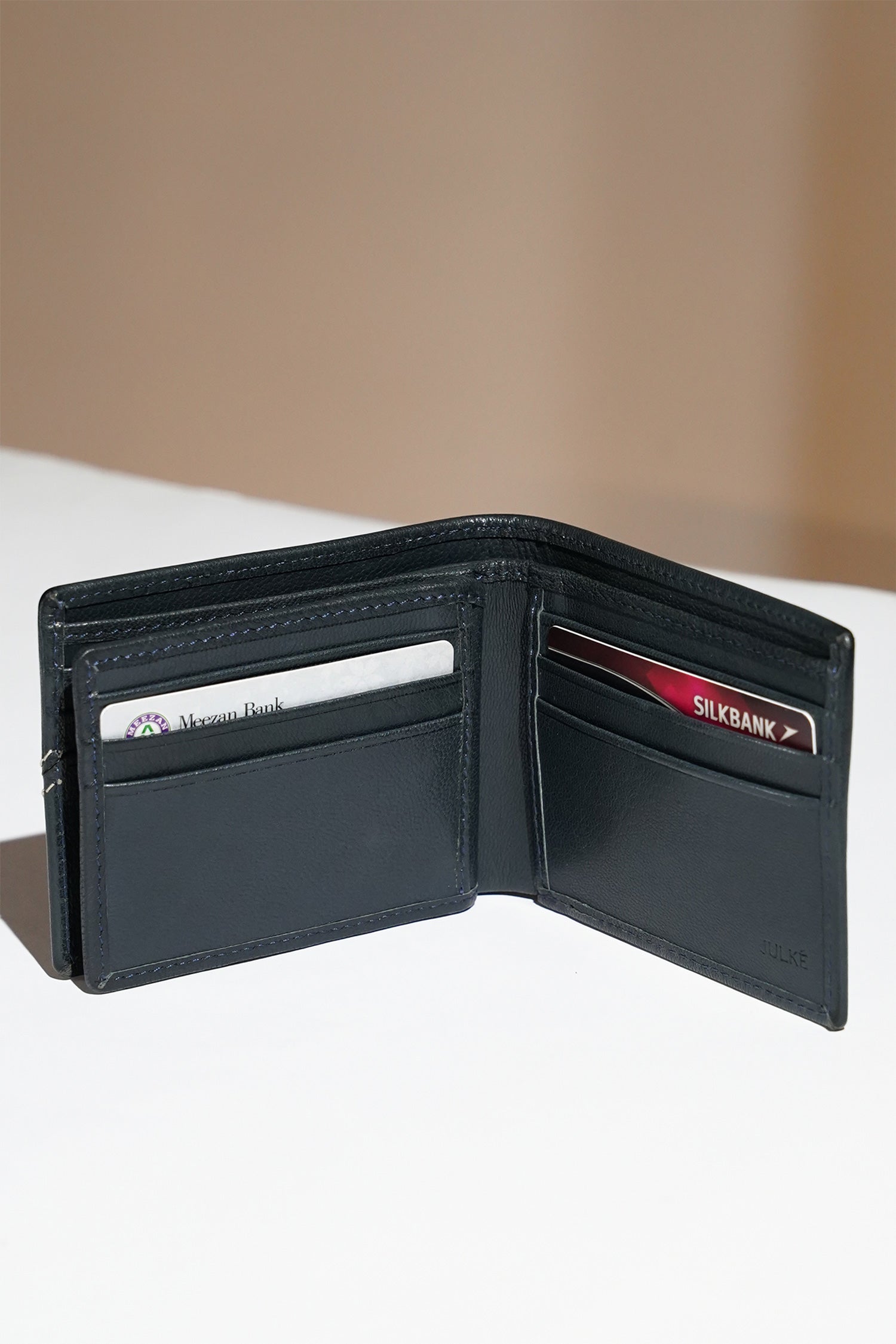 Mens leather bifold wallet in dark blue colour with white contrast stich and metallic hardware by JULKE