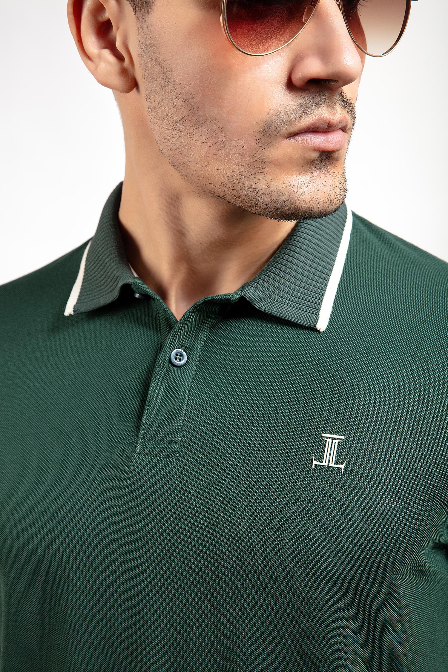 Mens summer polo shirt in dark green colour with matching white outline tipped collar and half sleeves by JULKE.