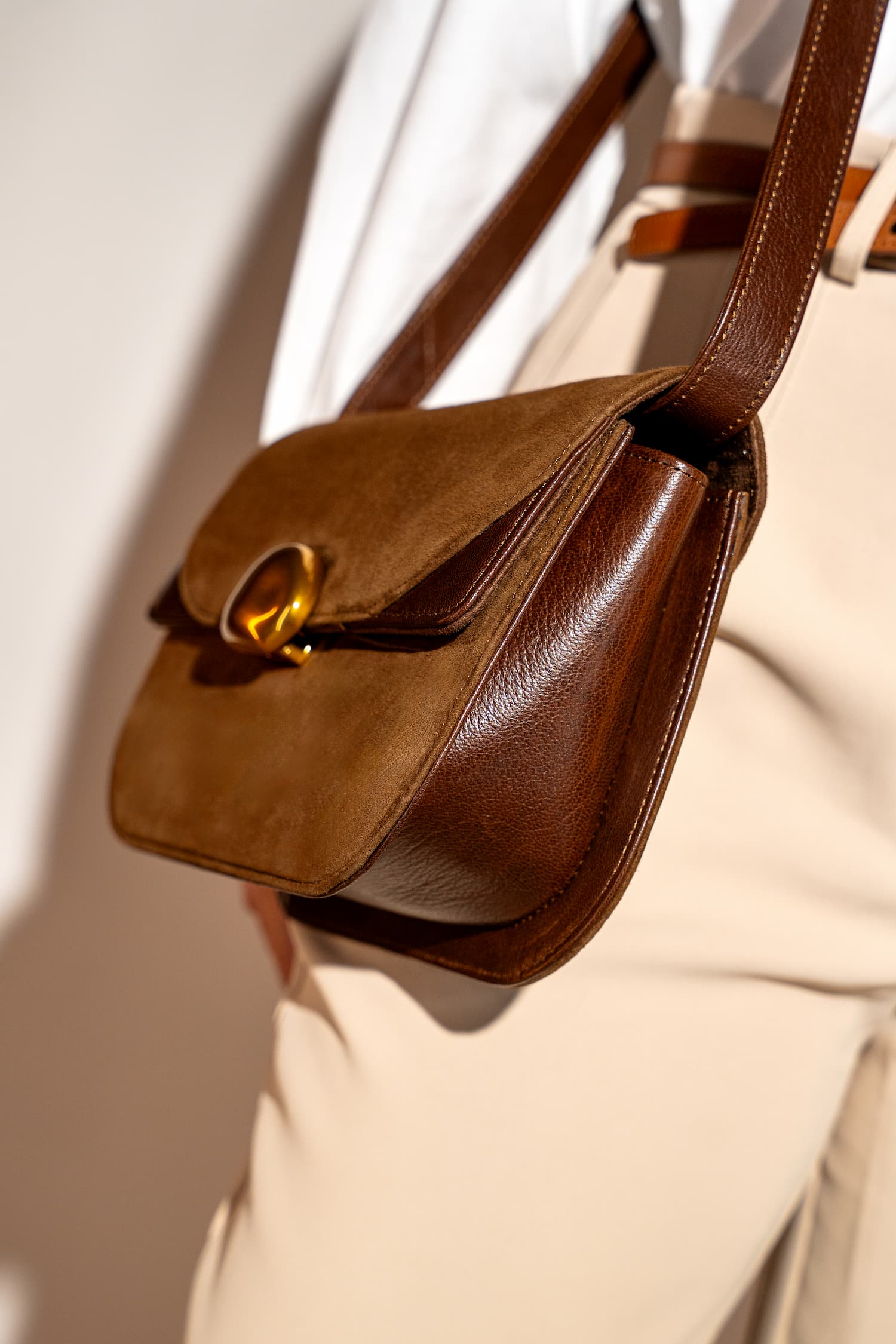 Womens suede & leather crossbody shoulder bag in brown colour with adjustabl shoulder strap and unqiue metallic gold push lock by JULKE