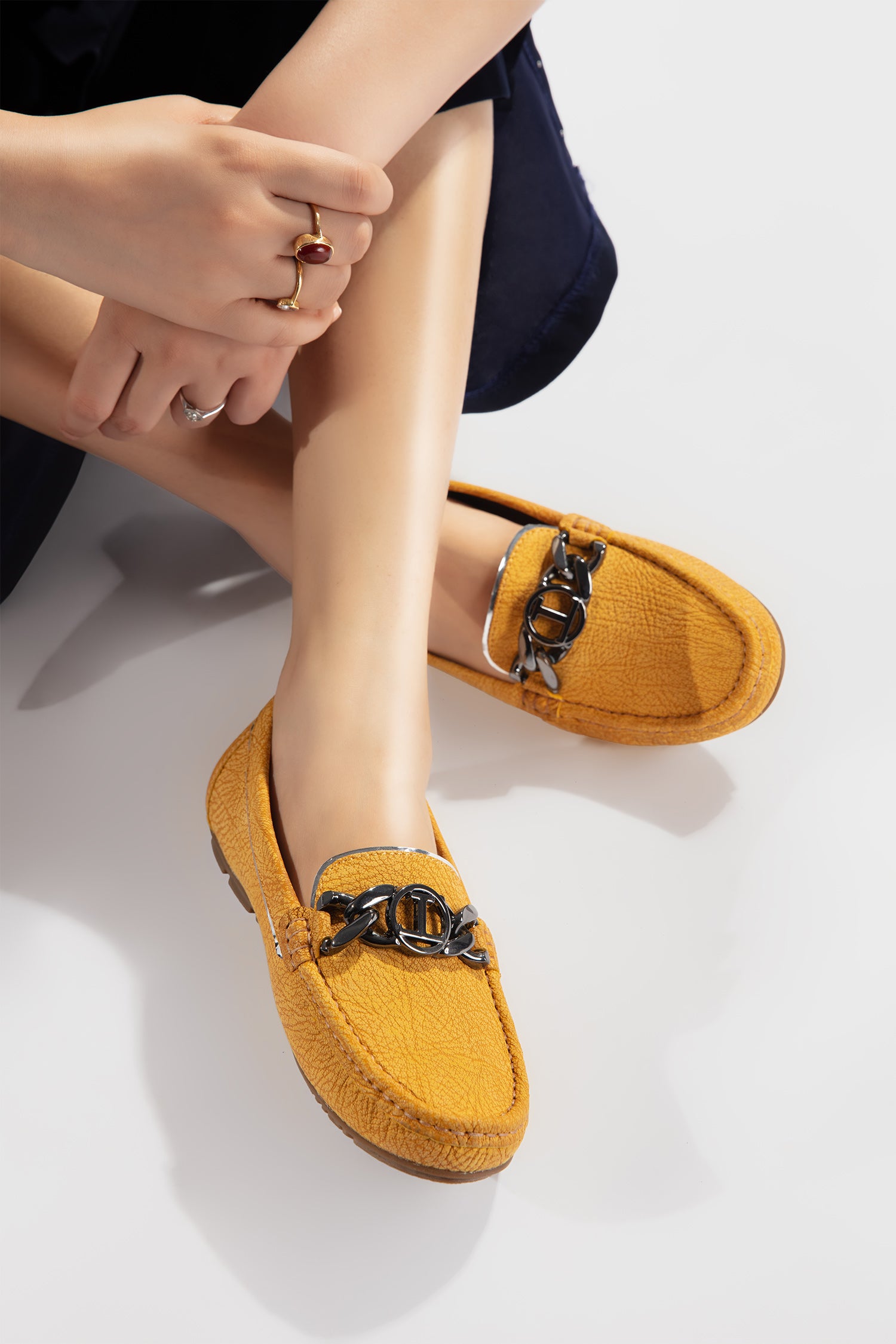Women leather moccasins in yellow colour with texture, metal chain and logo by JULKE