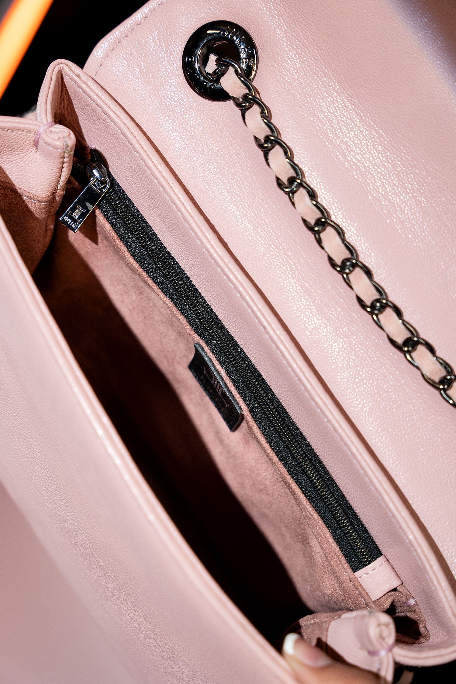 Women's leather shoulder bag in light pink colour with quilting and leatherette flower brooch by JULKE.