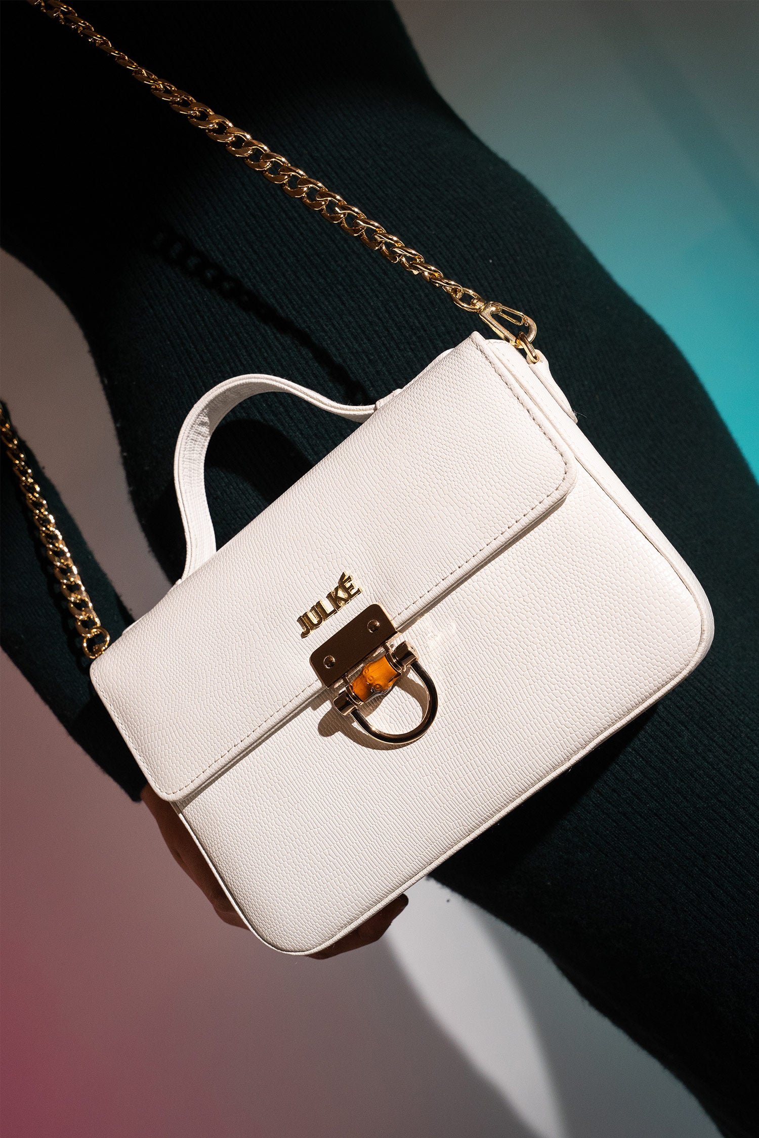 Women's leather top handle shoulder bag in white reptile texture with metal wood and metallic gold chain strap by JULKE