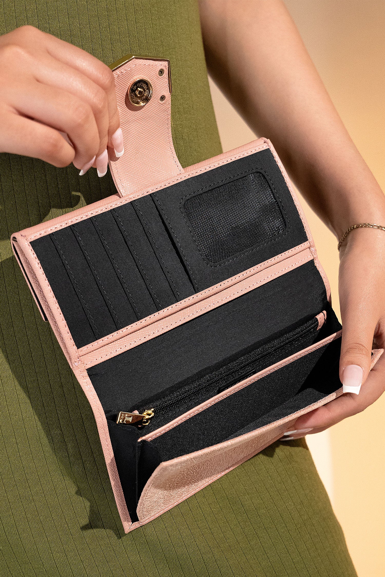 Women's leather long wallet in light pink colour in crosshatch texture with gold metal press button strap and extra pockets by JULKE.