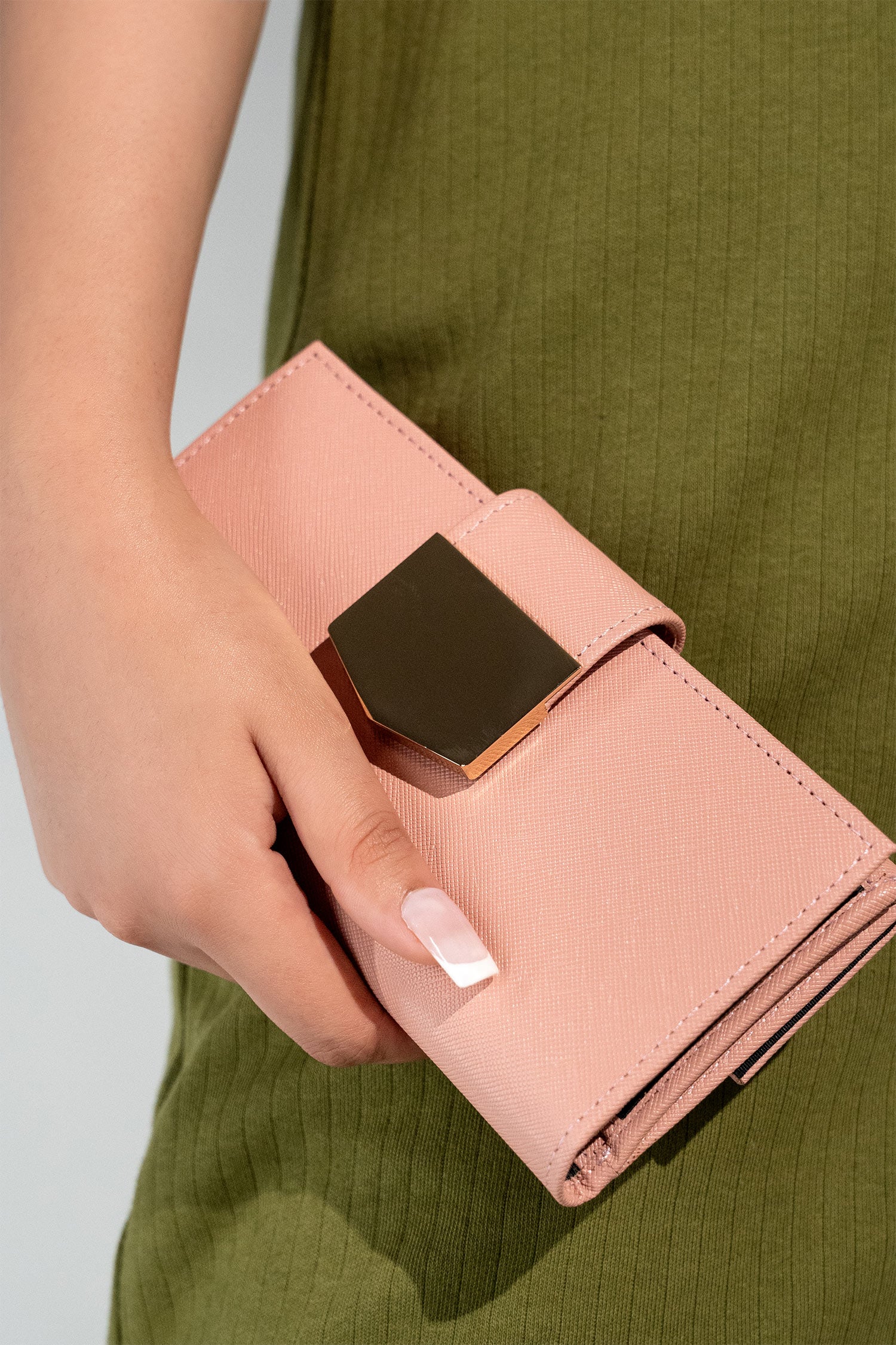 Women's leather long wallet in light pink colour in crosshatch texture with gold metal press button strap and extra pockets by JULKE.