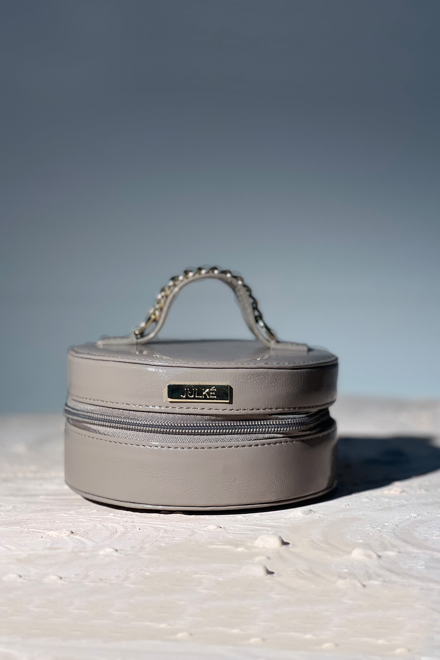 Women's leather round bag in grey colour for jewellery and accessories with top handle by JULKE