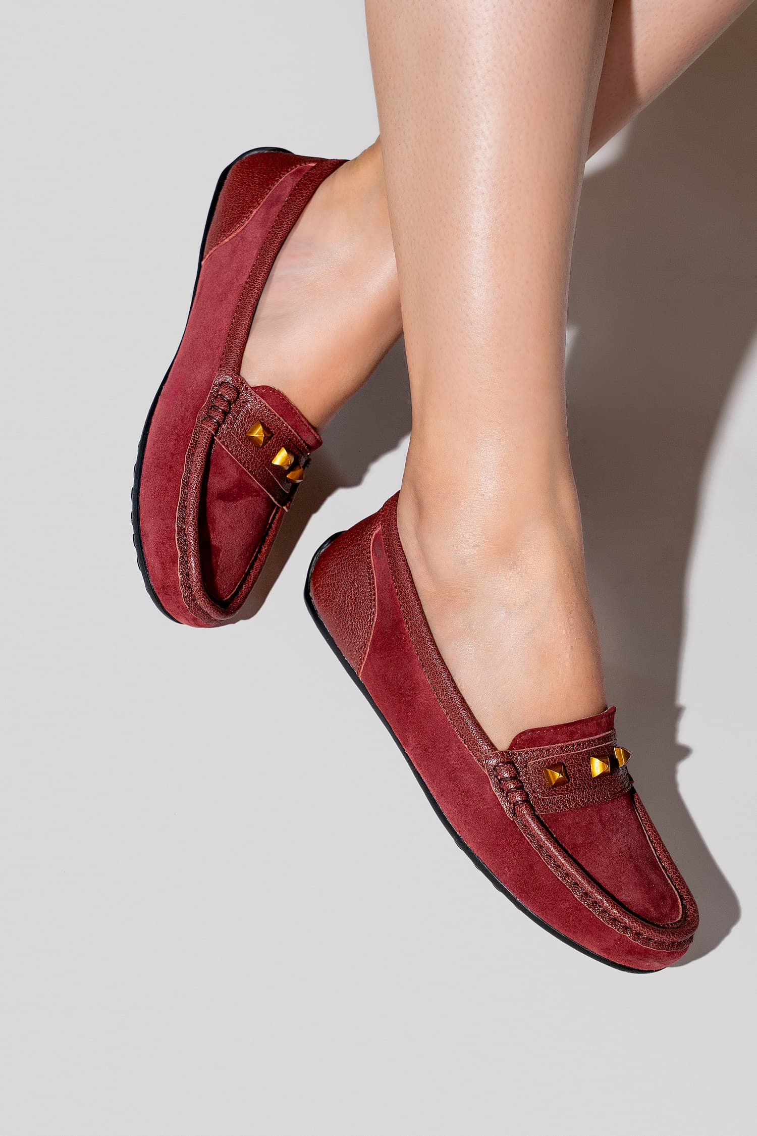 Womens suede leather moccasins in dark red colour with metallic gold studs by JULKE.