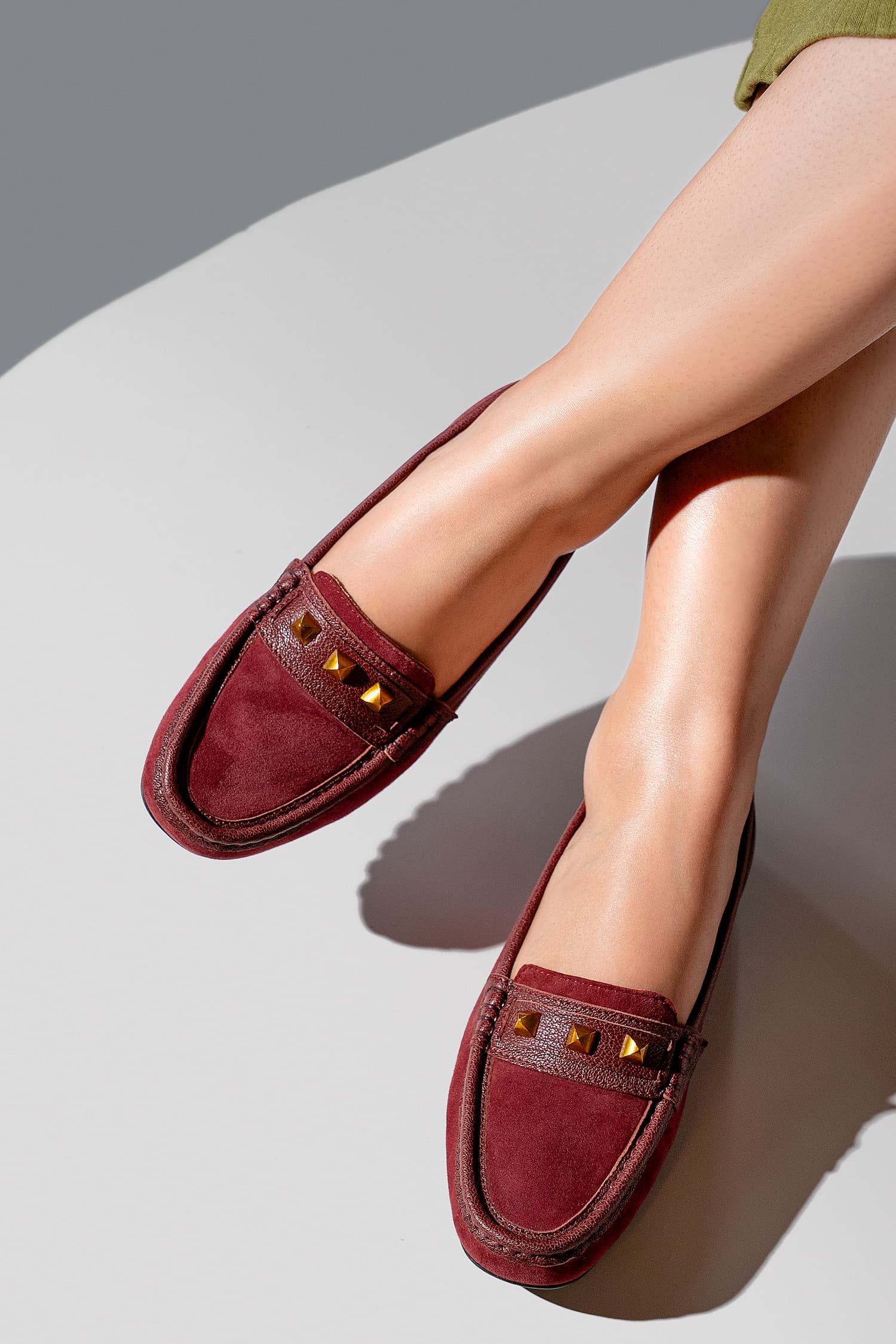 Womens suede leather moccasins in dark red colour with metallic gold studs by JULKE.