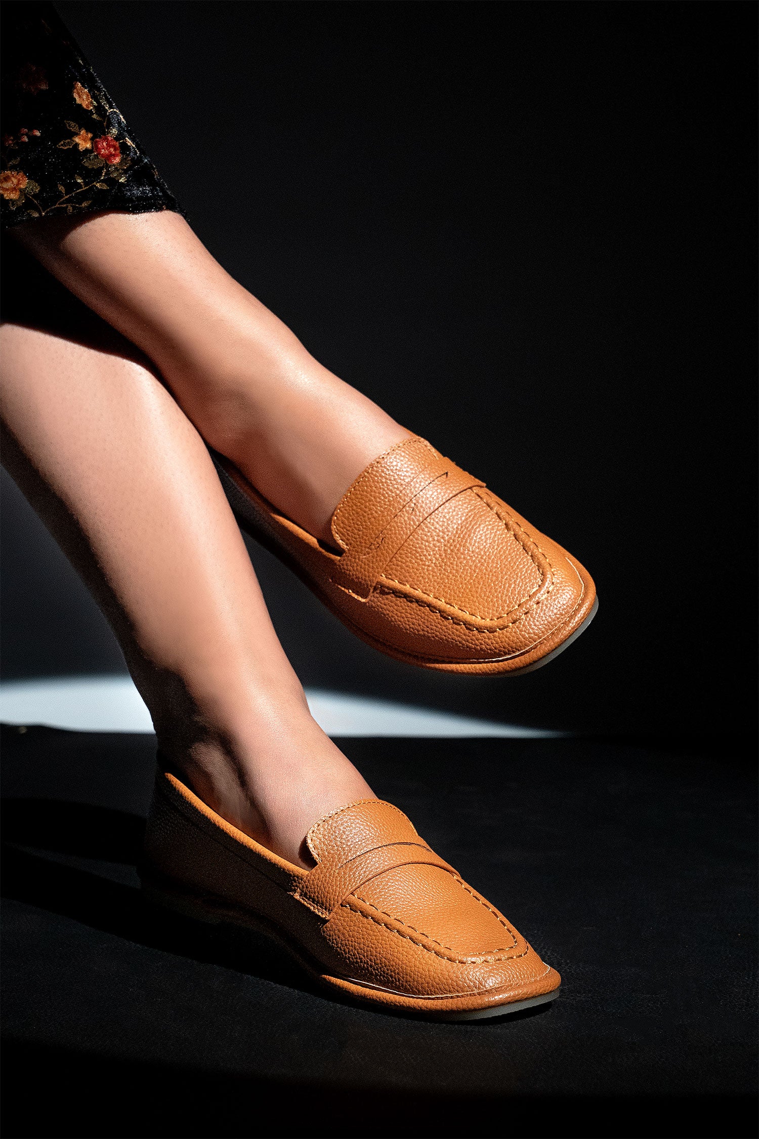 Women's flat moccasin style shoes in brown colour and leather texture with flexible transparent rubber sole and padded in-socks by JULKE.