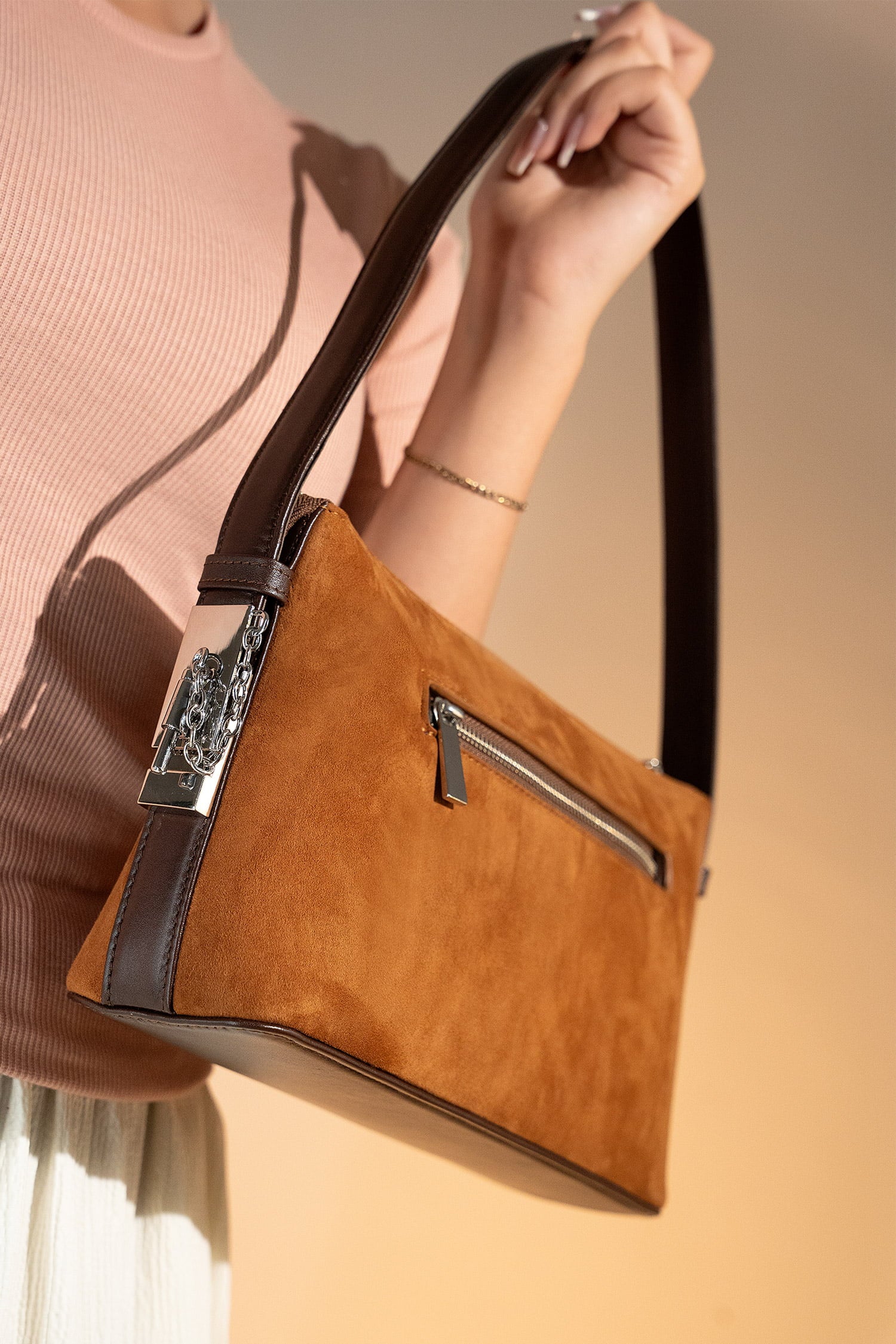 Women's suede leather mini shoulder bag in brown colour with contrast shoulder strap and metallic side lock by JULKE.
