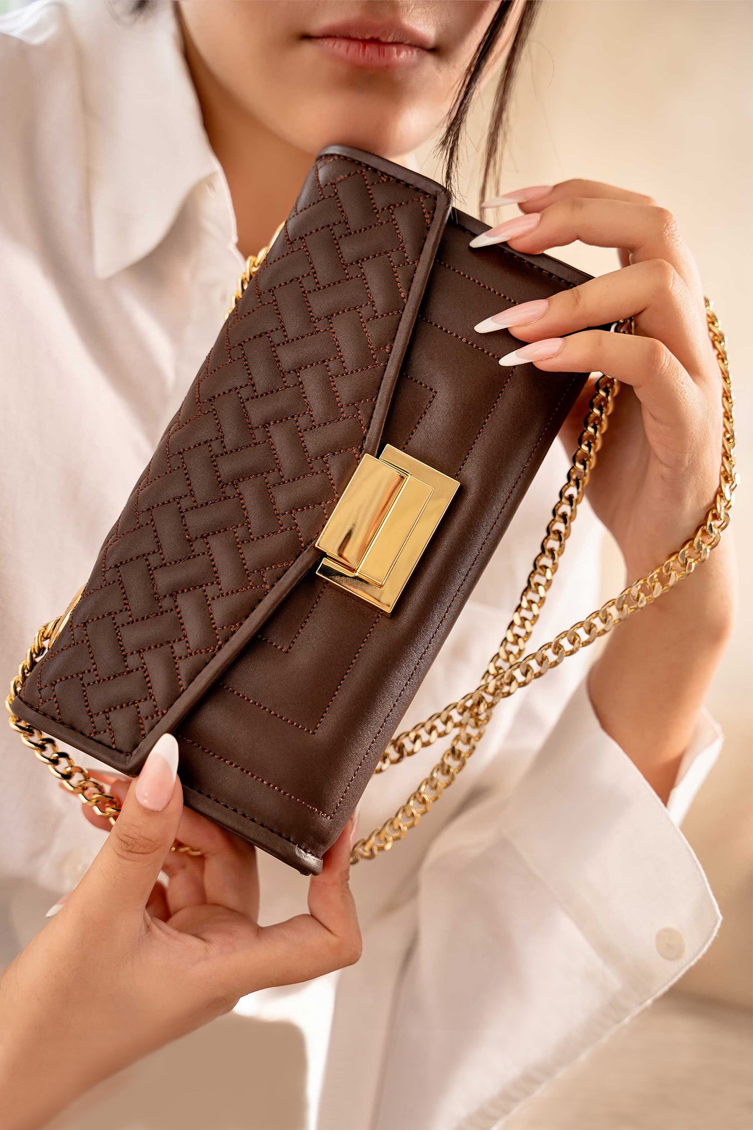 Womens leeather shoulder clutch bag in dark brown colour with weaving quilted front flap and metallic gold hardware by JULKE.