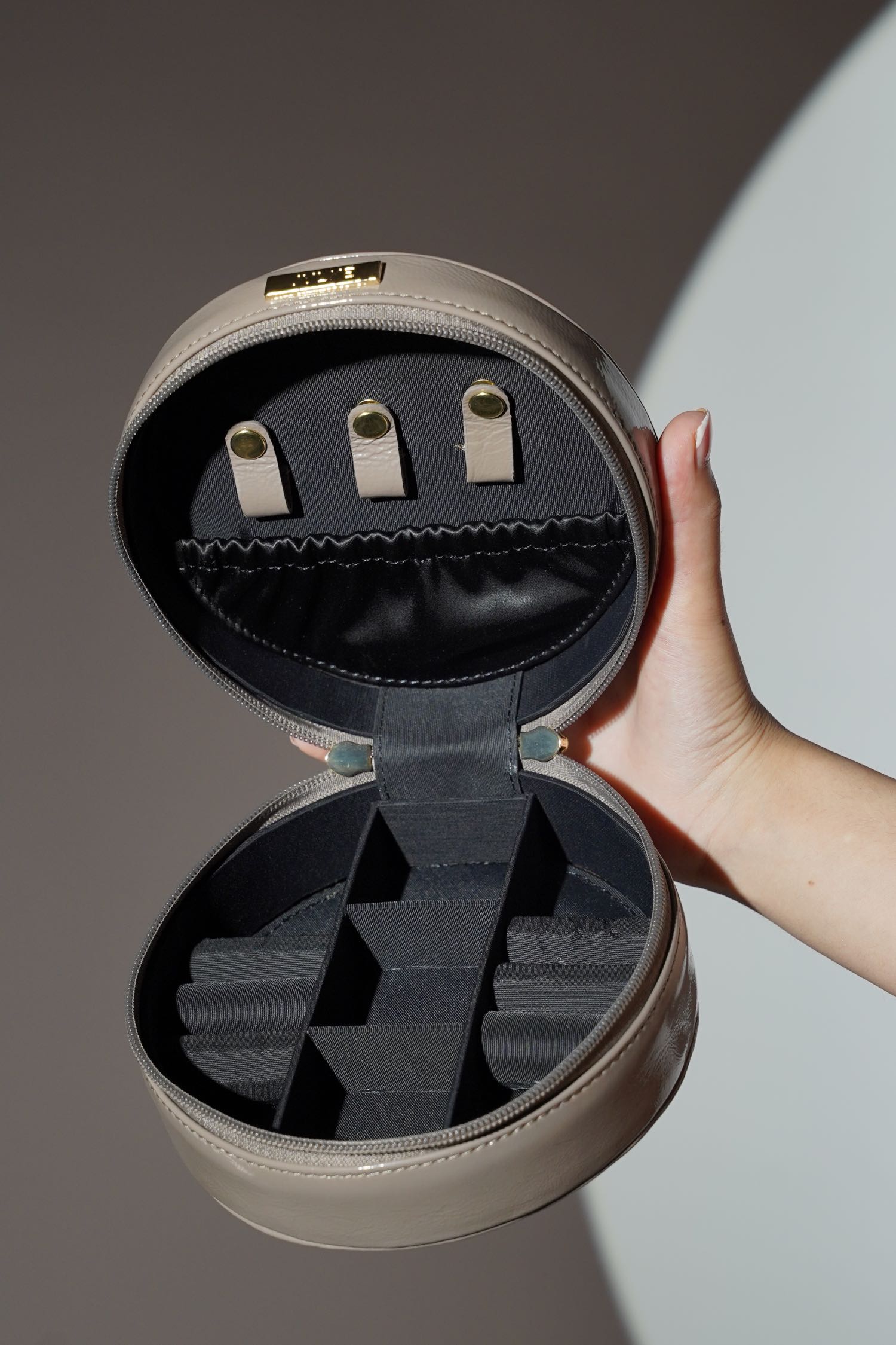 Women's leather round bag in grey colour for jewellery and accessories with top handle by JULKE