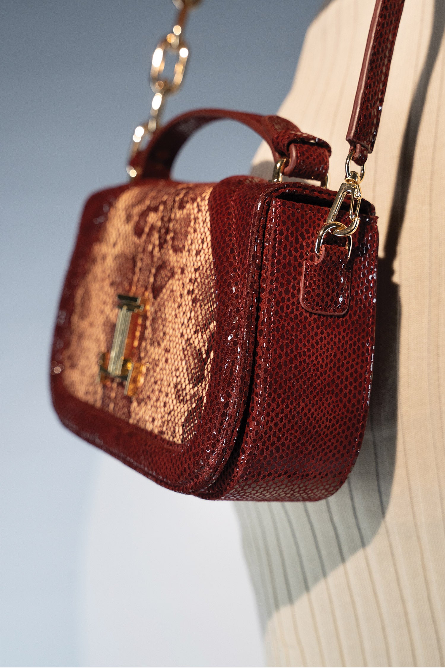 Women's leather top handle shoulder bag in dark red colour with snake print & texture by JULKE