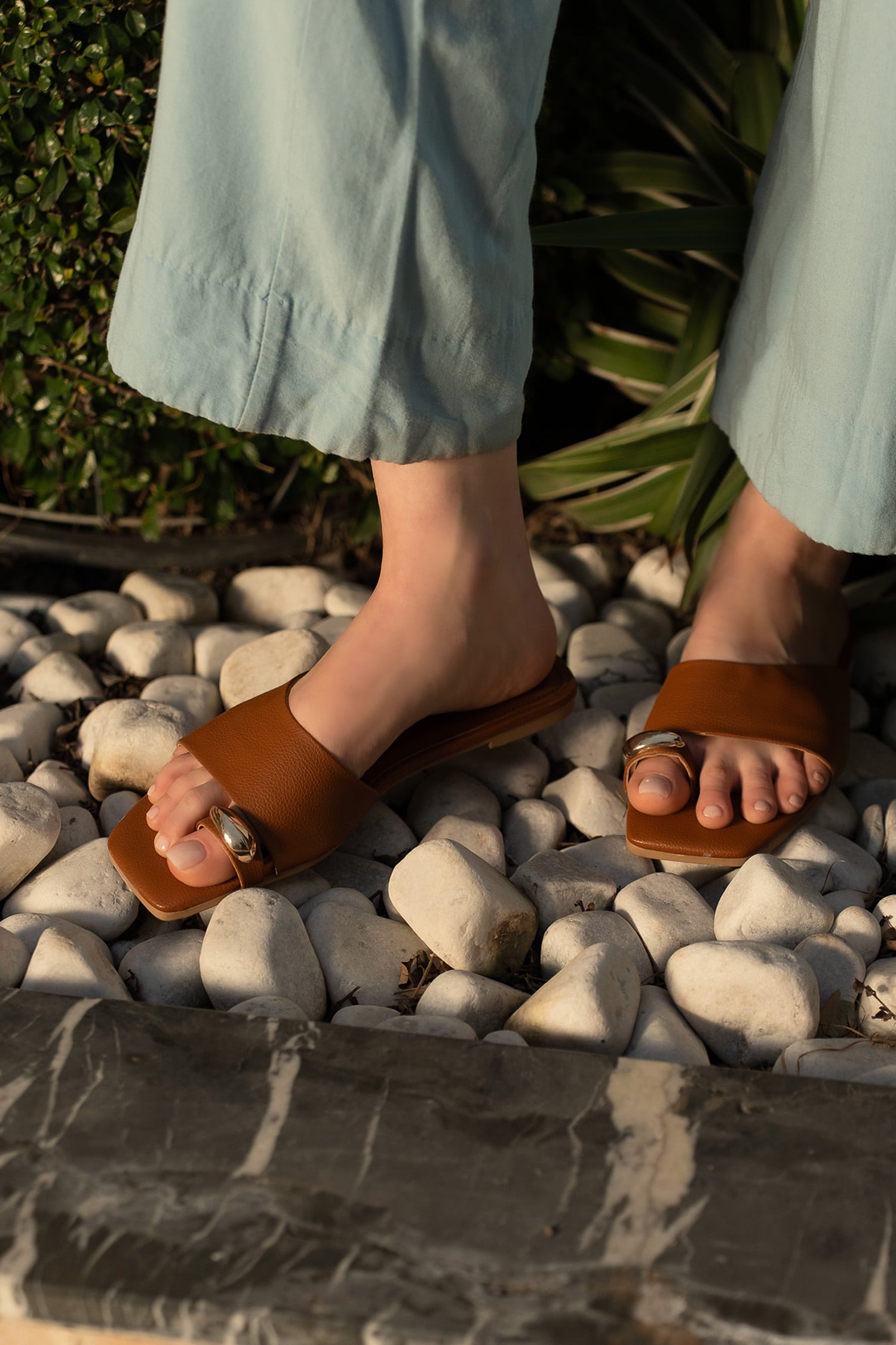 Womens flat slides in brown colour with toe strap and metallic golden toe ornament by JULKE.