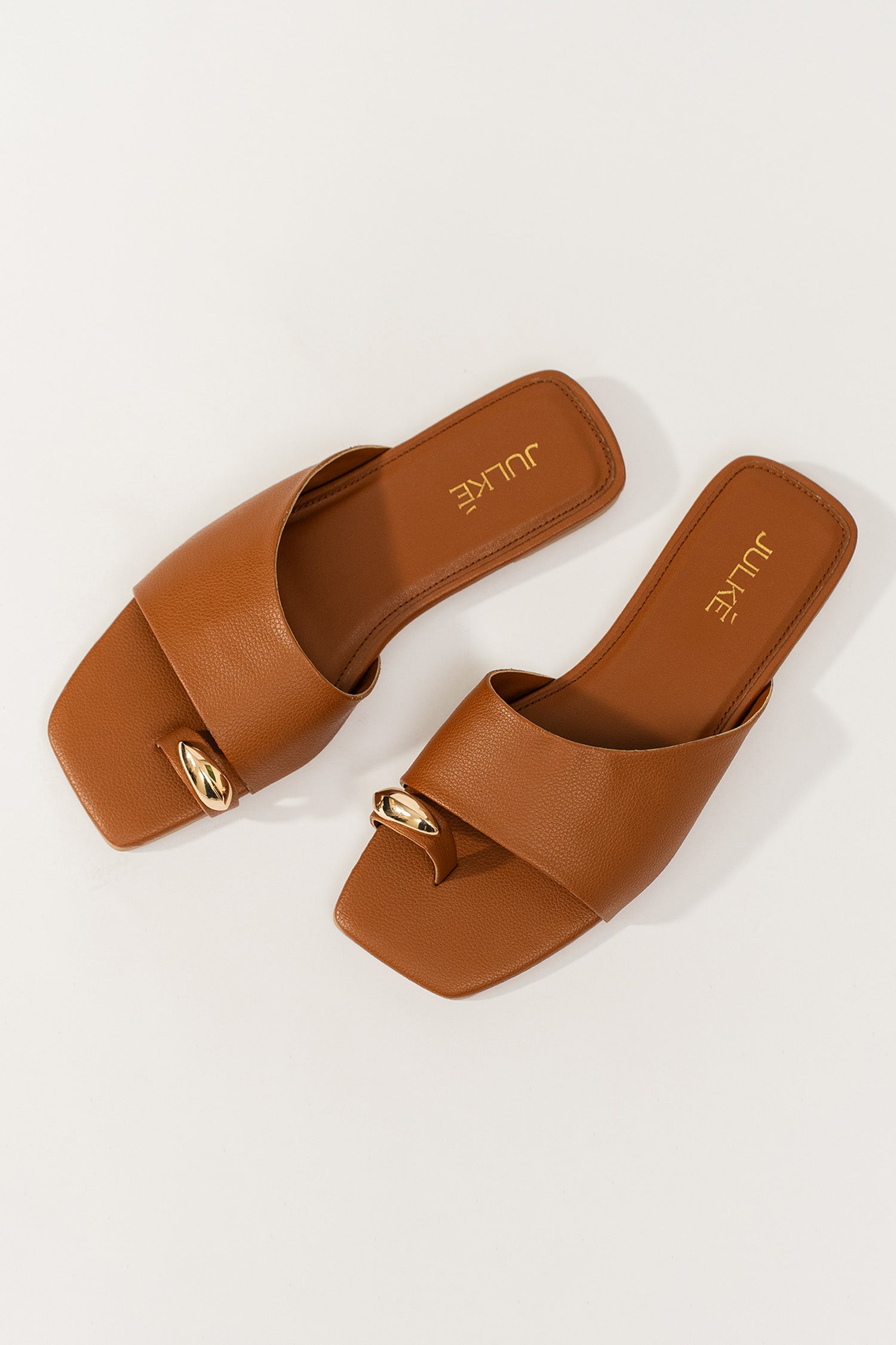 Womens flat slides in brown colour with toe strap and metallic golden toe ornament by JULKE.