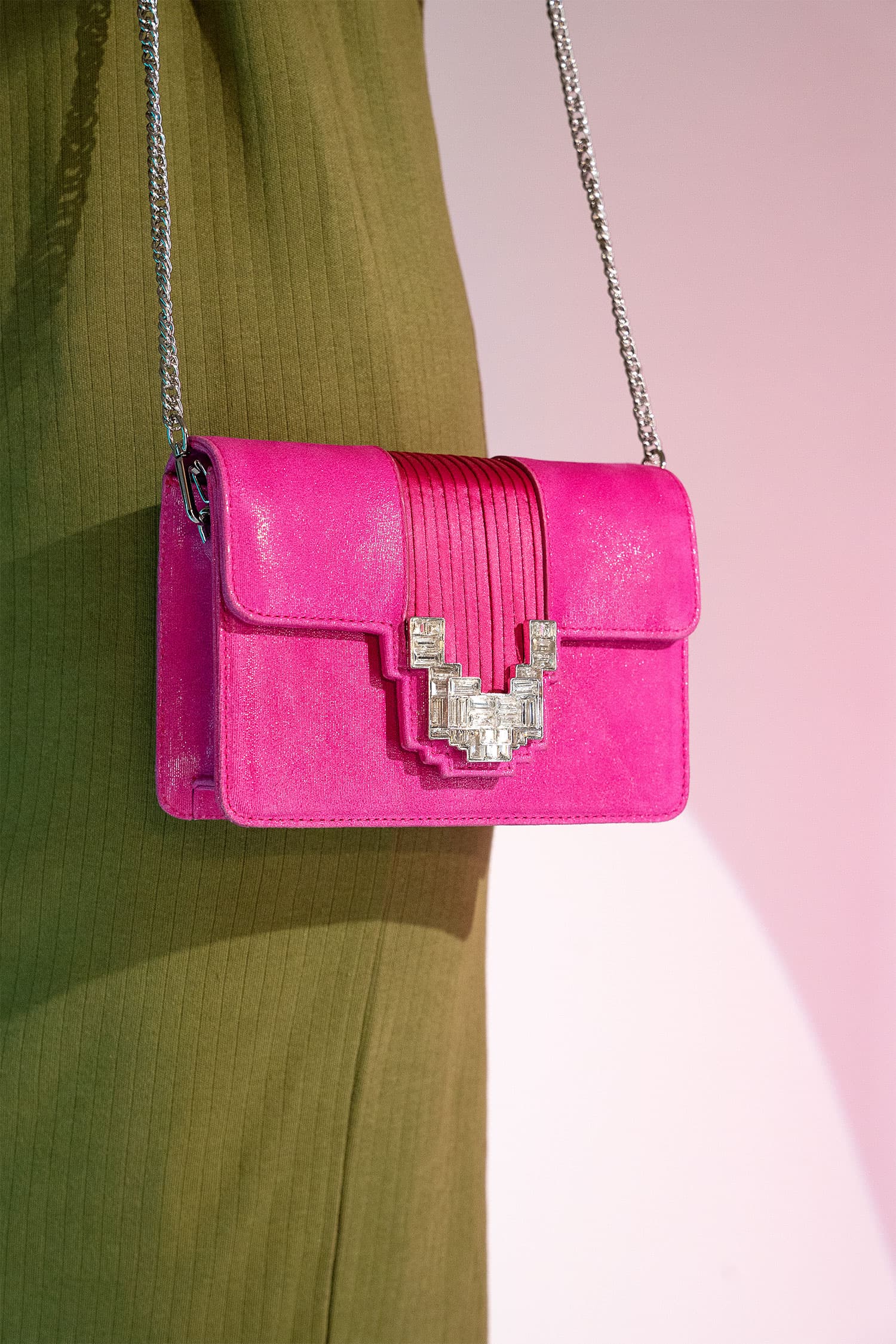 Women's suede leather clutch bag in shiny pink colour with satin pleated flap and geometric transparent rhinestone brooch by JULKE.