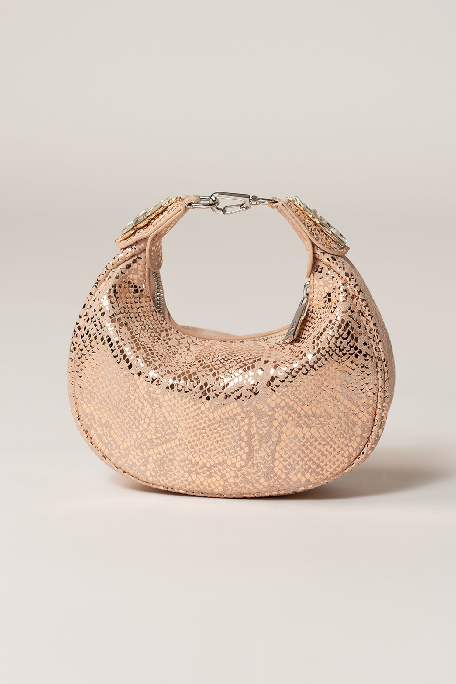 Women's leather mini halfmoon bag in light pink colour with 3d reptile texture and unique clip-on handle by JULKE.