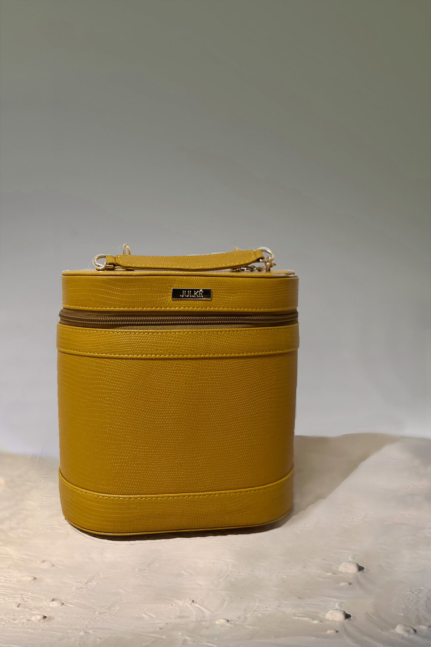 Women's leather cosmetics vanity trunk in mustard yellow colour with gold metallic chain handle by JULKE