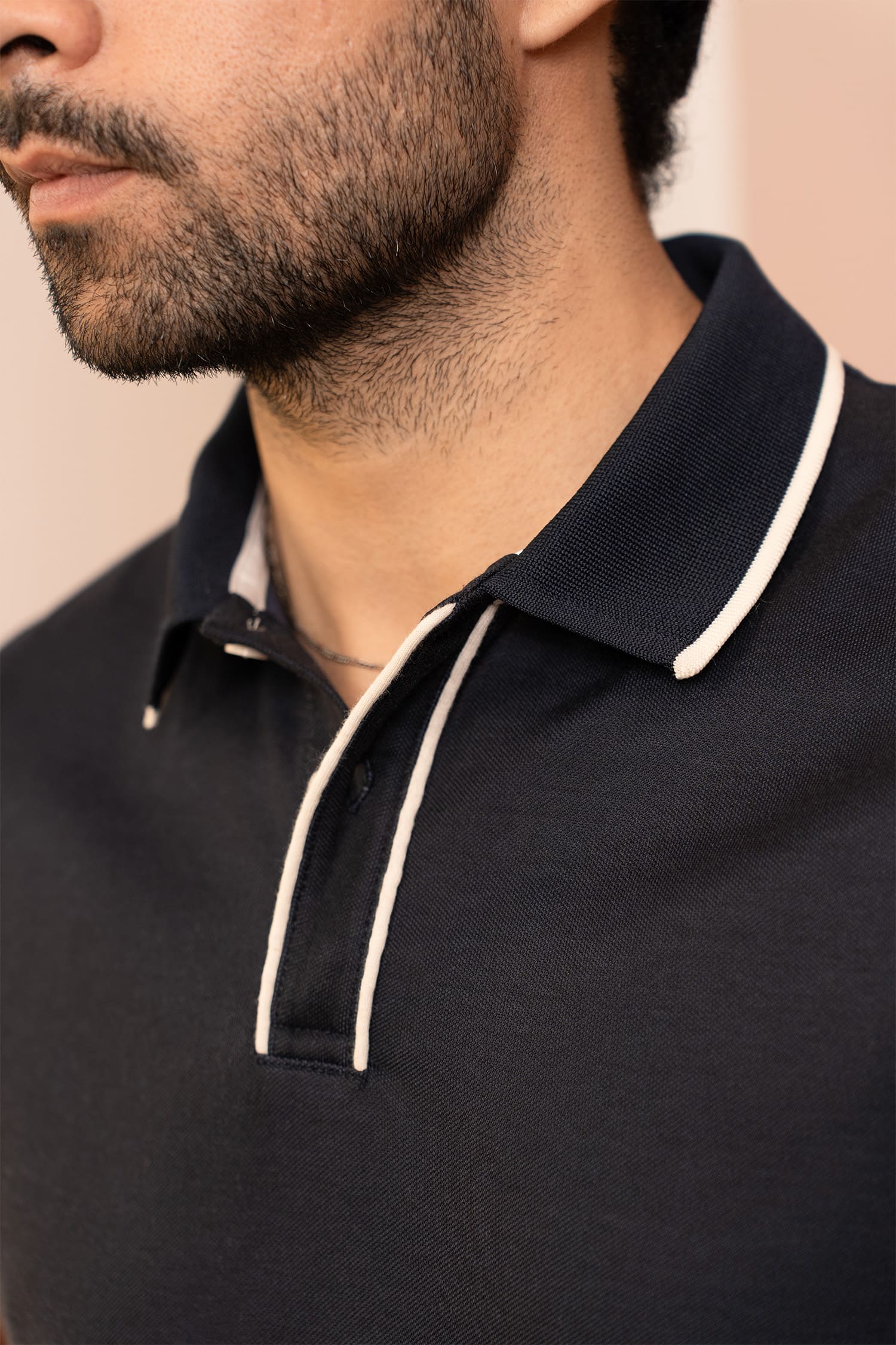 Mens half sleeve polo shirt in black colour with white buttons and white contrast tipping at collar placket and sleeves by JULKE.