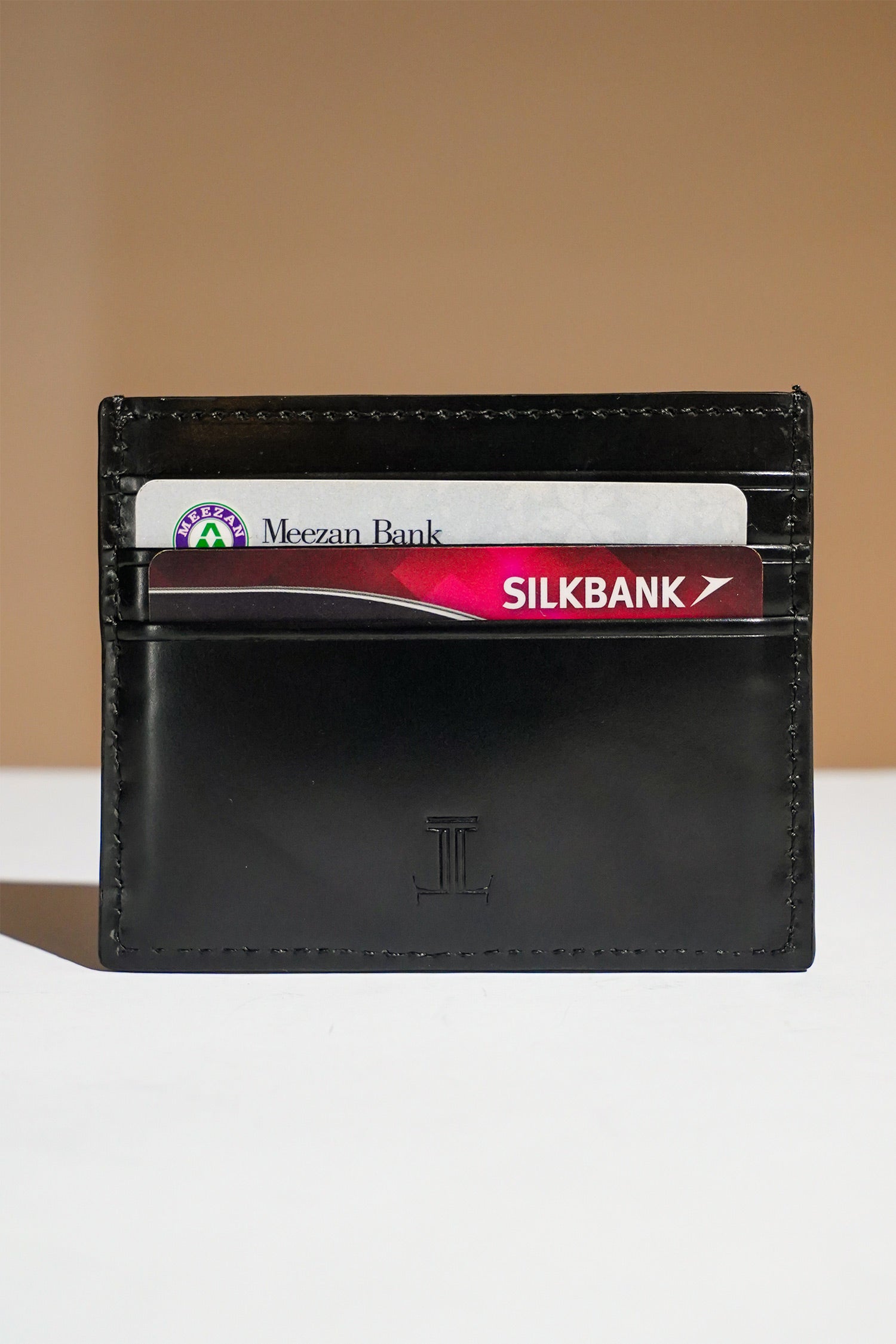 Mens leather card holder in black colour with diagonal white contrast stitch and metallic hardware by JULKE