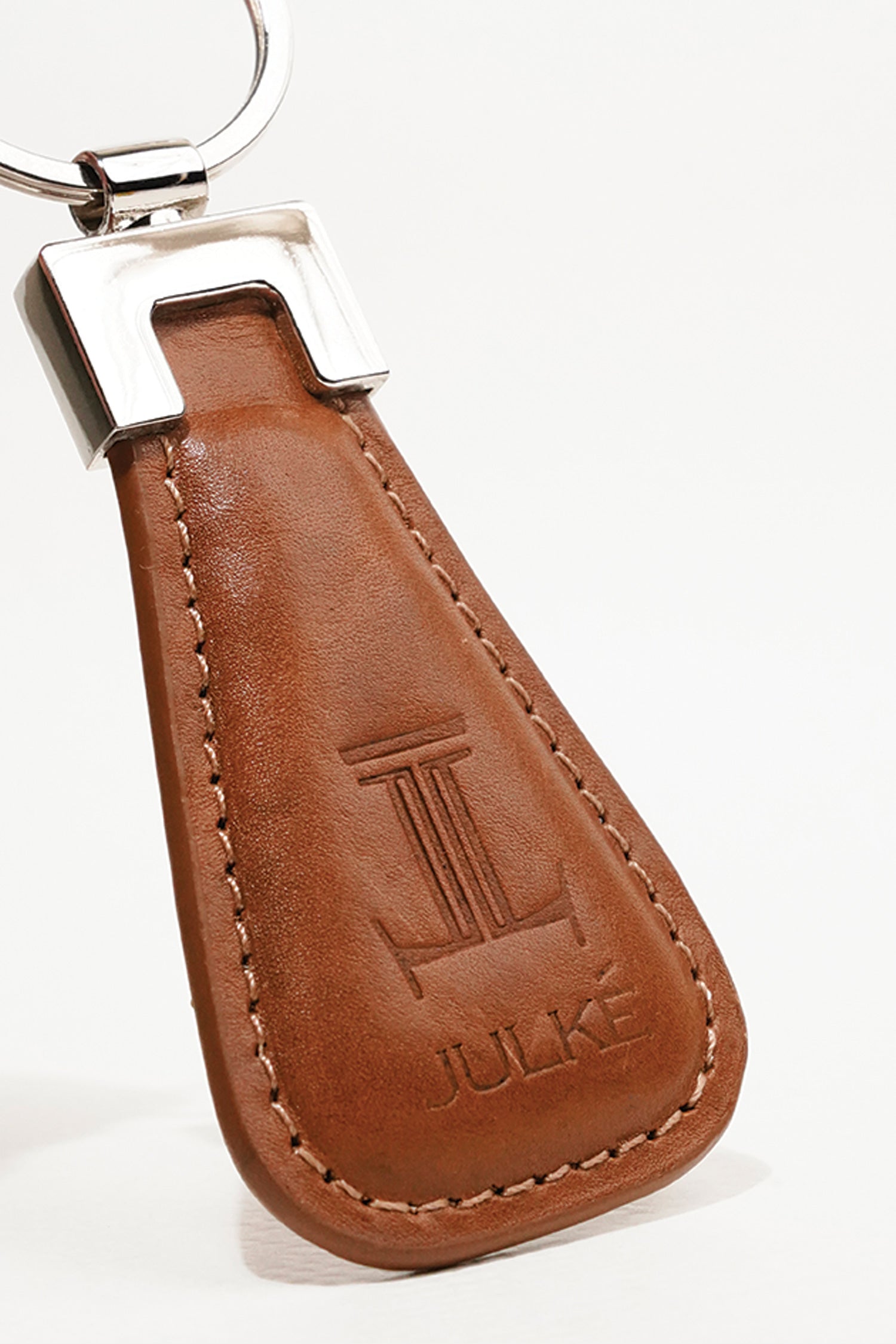 Leather key chain in tan colour in geometric shape and metal ring by JULKE
