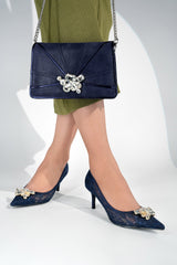 Women's  pointed toe high heel pumps in navy blue with matching leather shoulder clutch bag in chantilly lace material with big rhinestone buckle by JULKE.