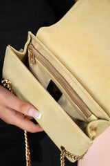 Women's leather shoulder clutch bag in light gold colour with satin piping and rhinestone brooch by JULKE. 