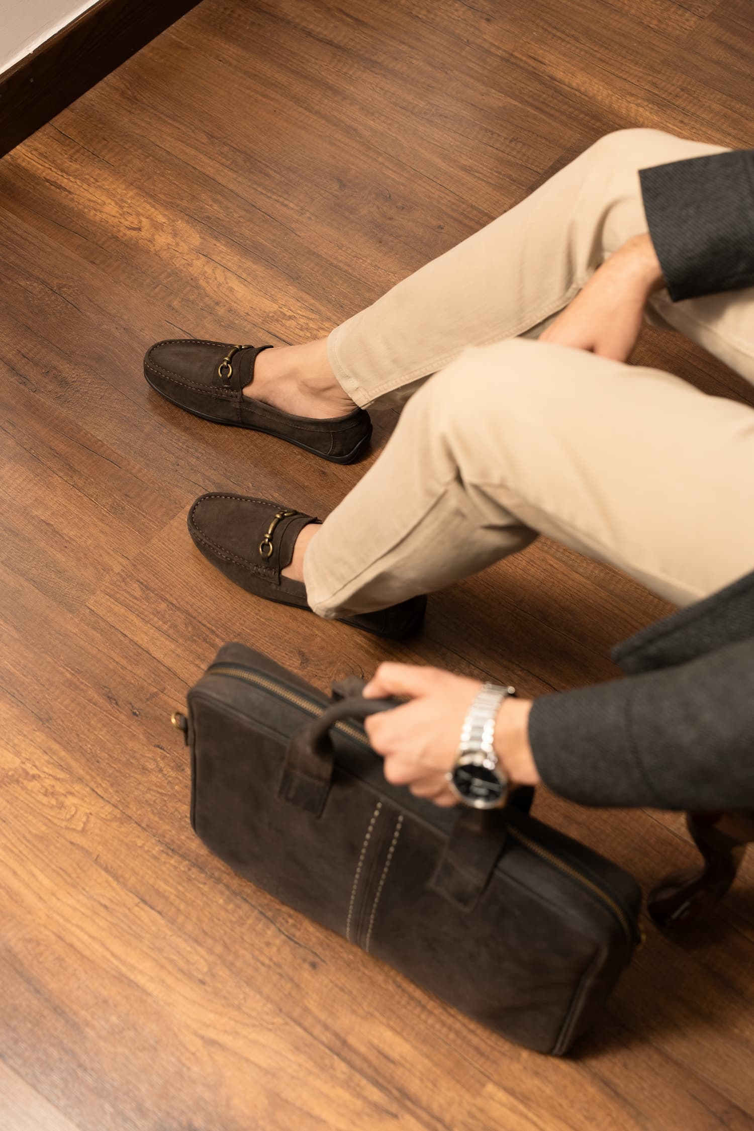 Mens suede leather moccasins in brown colour with metallic dull gold hardware and matching leather laptop bag by JULKE. 