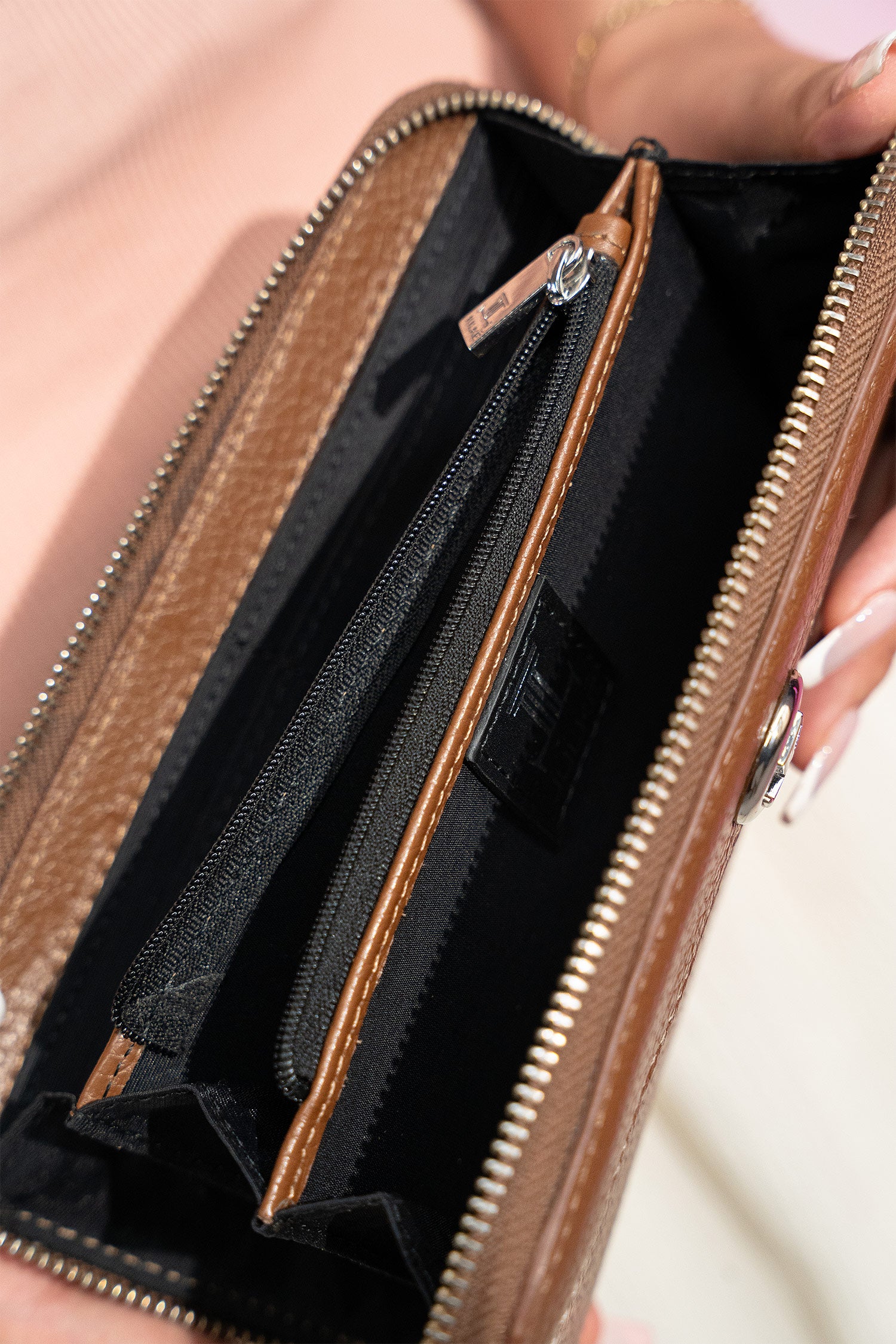 Women's leather long wallet in brown colour with zipper closure contrast stitch and metal brand logo by JULKE. 