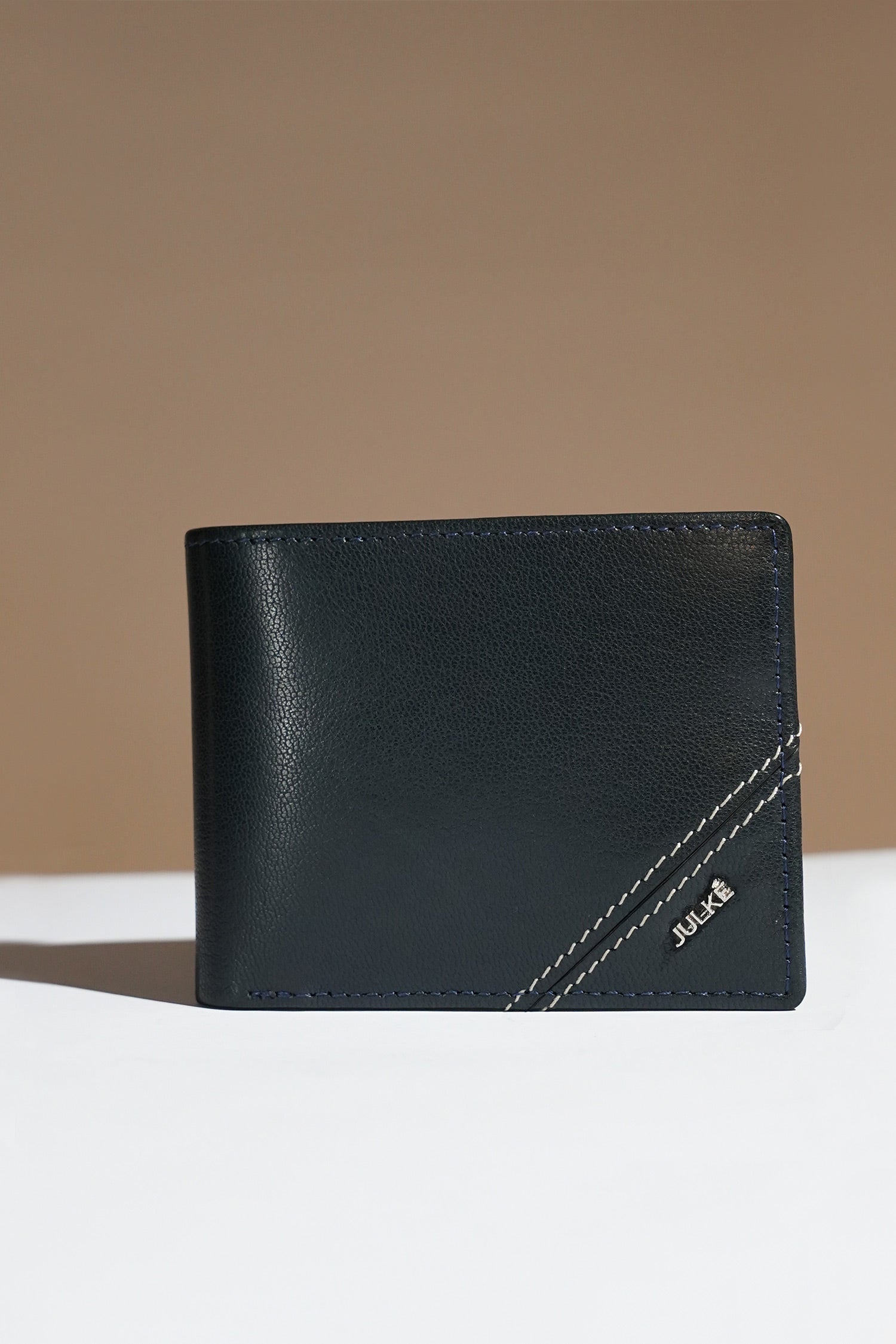 Mens leather bifold wallet in dark blue colour with white contrast stich and metallic hardware by JULKE