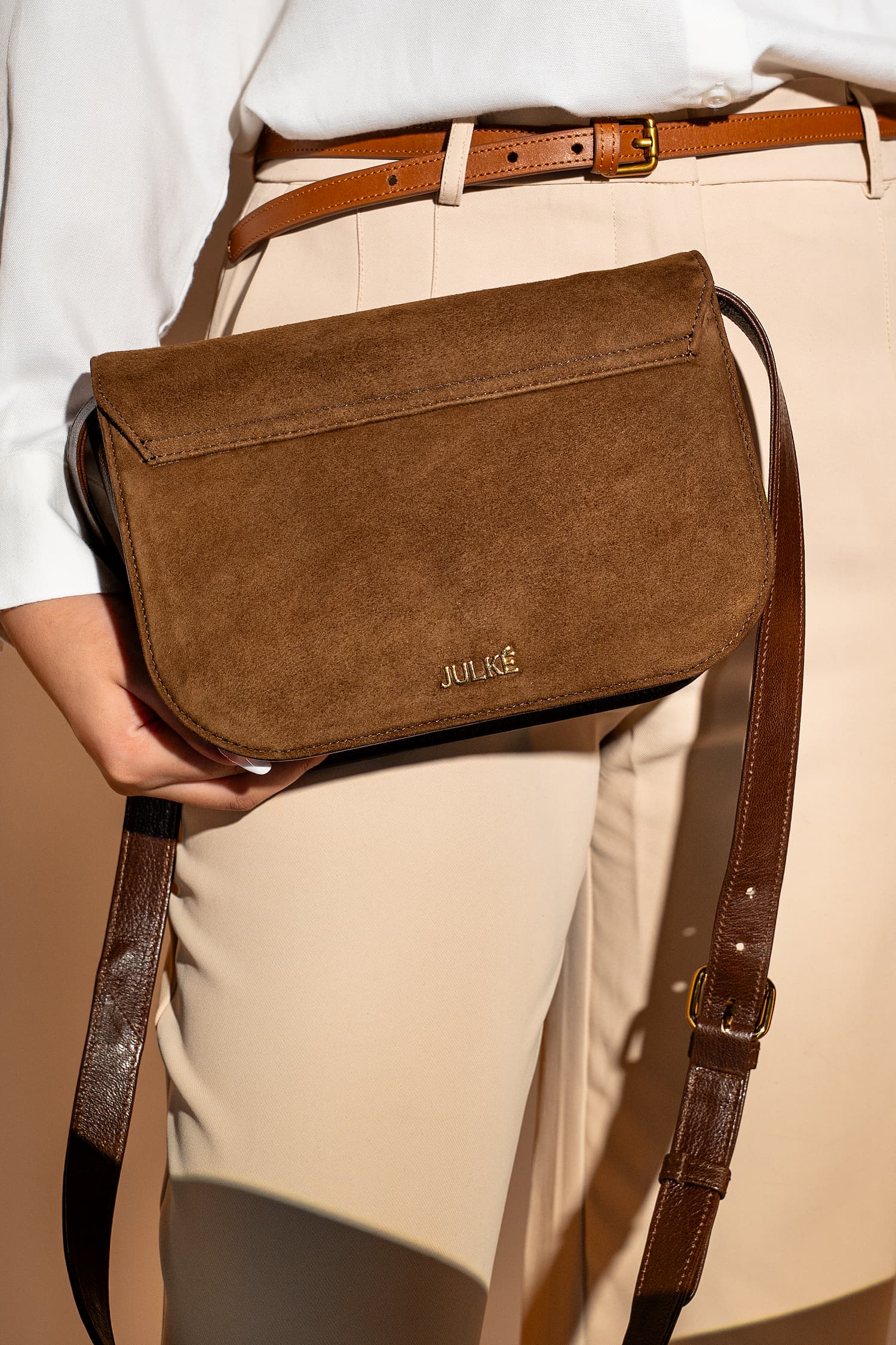 Womens suede & leather crossbody shoulder bag in brown colour with adjustabl shoulder strap and unqiue metallic gold push lock by JULKE 