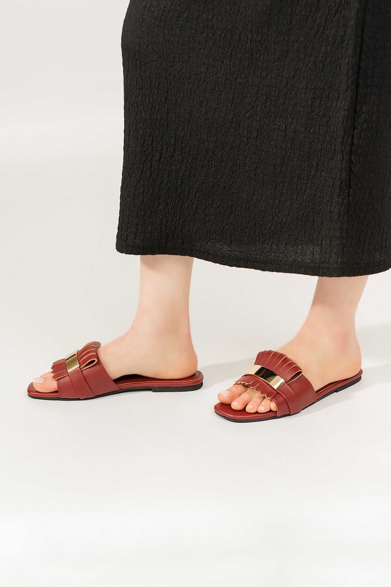 Womens leather flat shoes in dark maroon colour with matching fringe and metallic gold leather strap by JULKE. 
