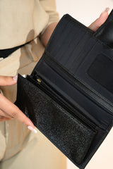 Women's leather long wallet in black colour in crosshatch texture with gold metal press button strap and extra pockets by JULKE. 