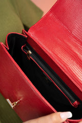 Women's reptile texture leather top handle bag in red colour with detachable shoulder strap and unique oval twist lock by JULKE. 