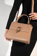 Women's reptile texture leather top handle bag in beige colour with detachable shoulder strap and unique oval twist lock by JULKE. 
