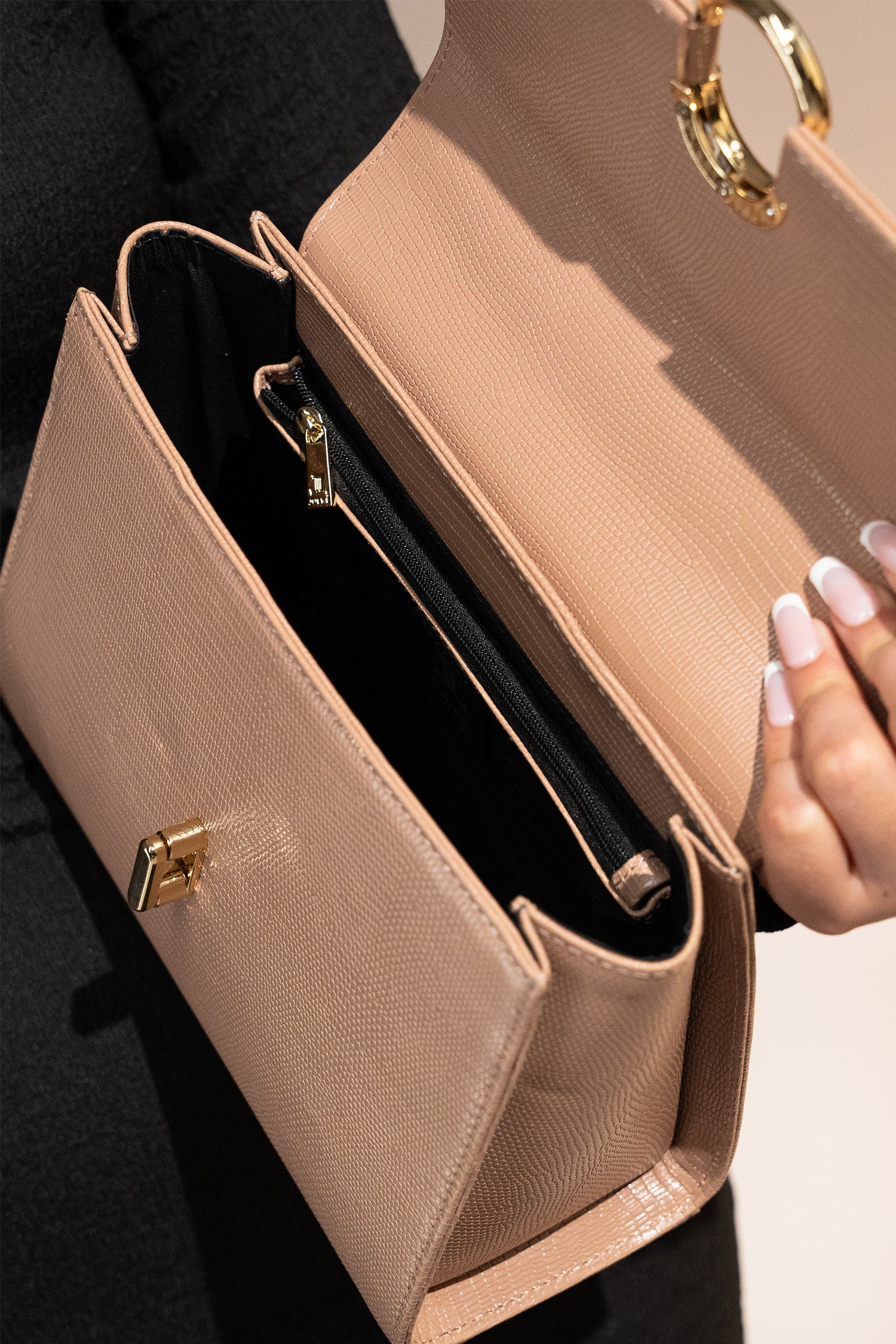 Women's reptile texture leather top handle bag in beige colour with detachable shoulder strap and unique oval twist lock by JULKE. 