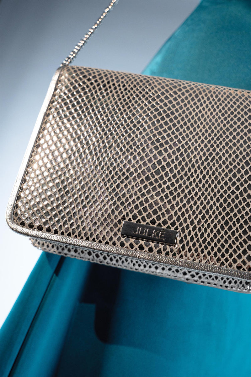 Women's leather reptile texture shoulder clutch bag in silver colour with rhinestones and detachable golden shoulder chain by JULKE. 