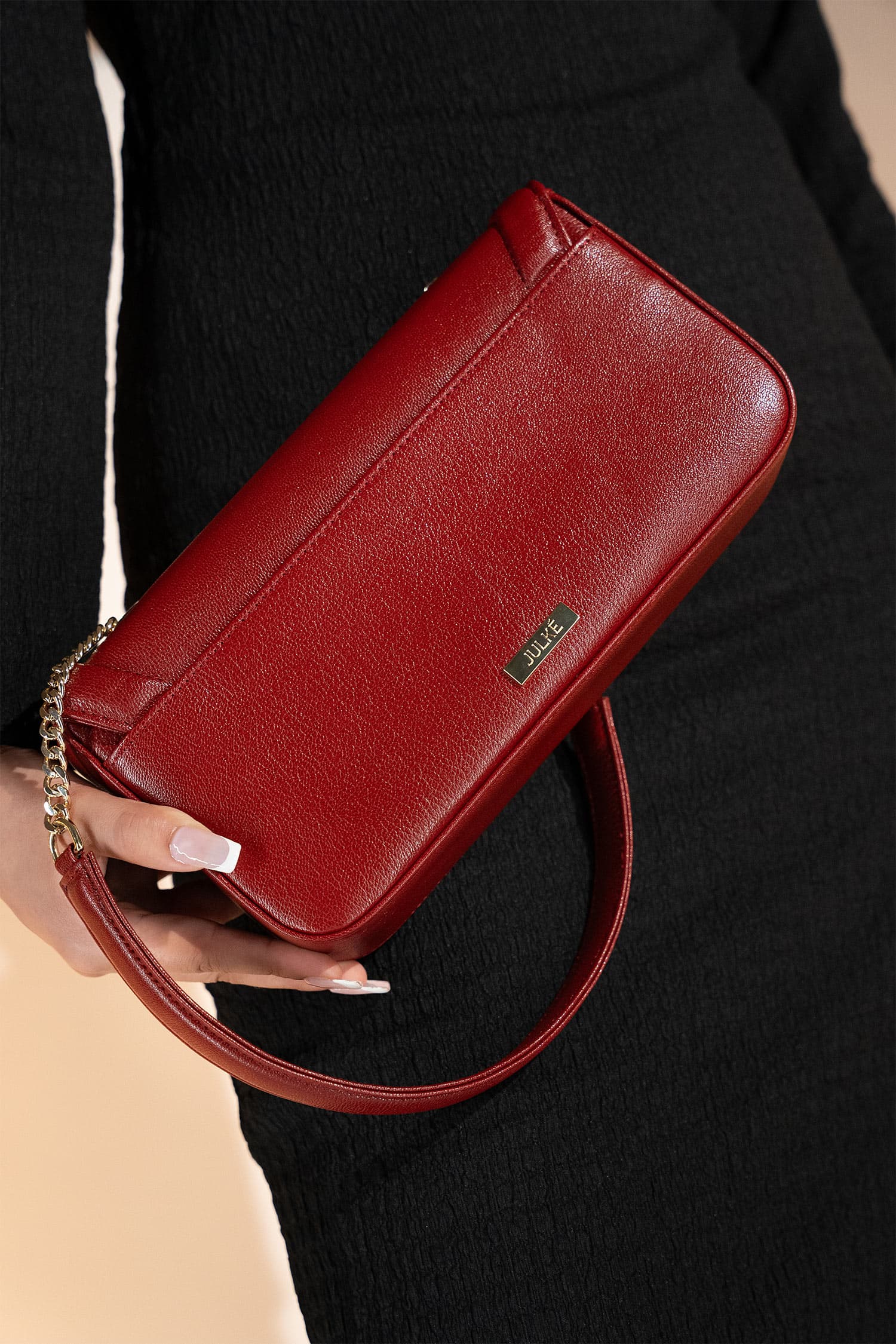 Women's leather shoulder bag in maroon colour in rectangular shape with gold horse-bit buckle of transparent circle rhinestones and short chain and leather shoulder strap by JULKE