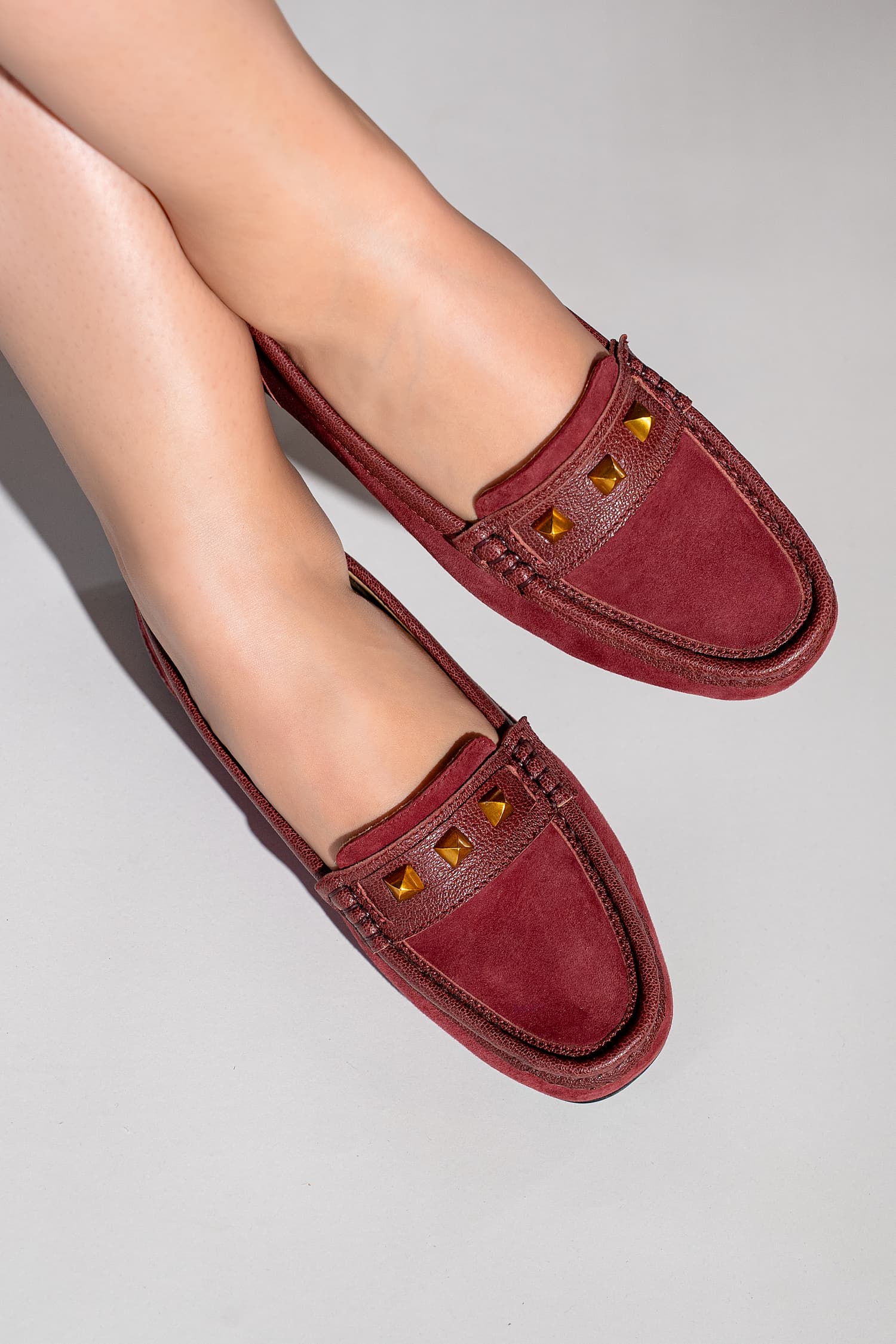 Womens suede leather moccasins in dark  red colour with metallic gold studs by JULKE. 
