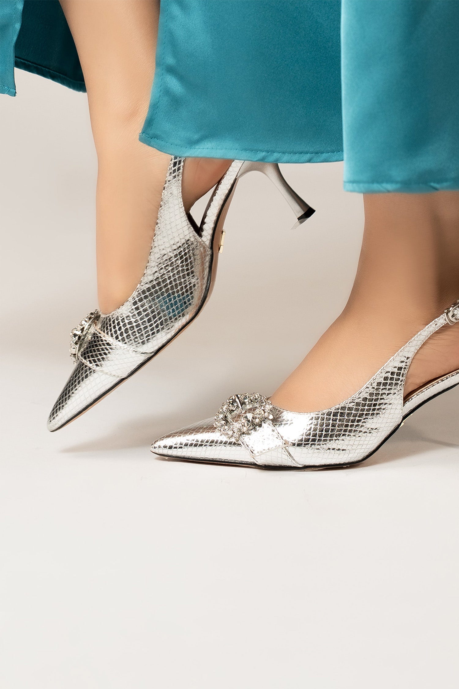 Womens slingback pointed toe heels in silver colour with metallic reptile texture and diamante buckle by JULKE. 