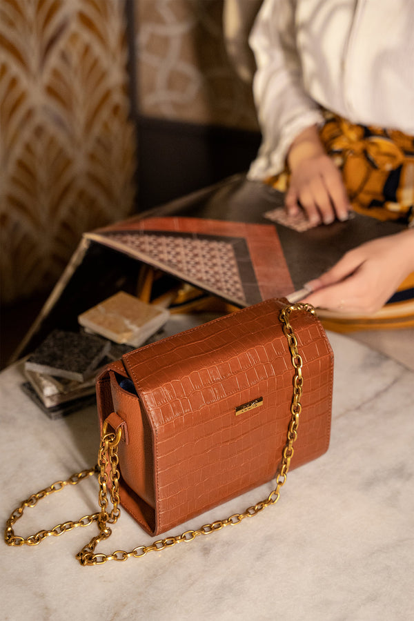 Womens leather shoulder bag in brown colour with croc texture and gold chain by JULKE