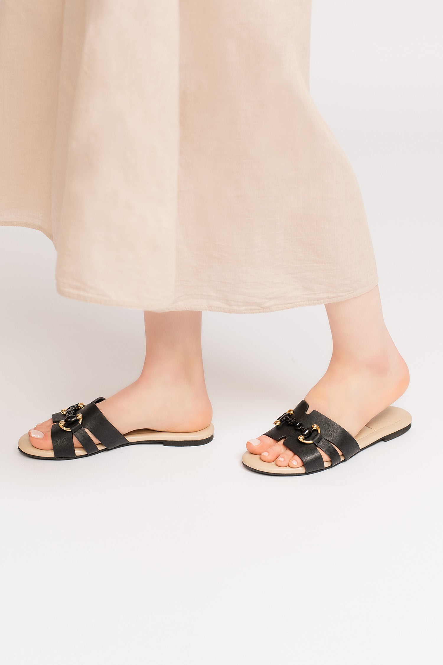 Women's summer leather flats In black colour with beige padded in-sock and gold black horse-bit buckle  by JULKE