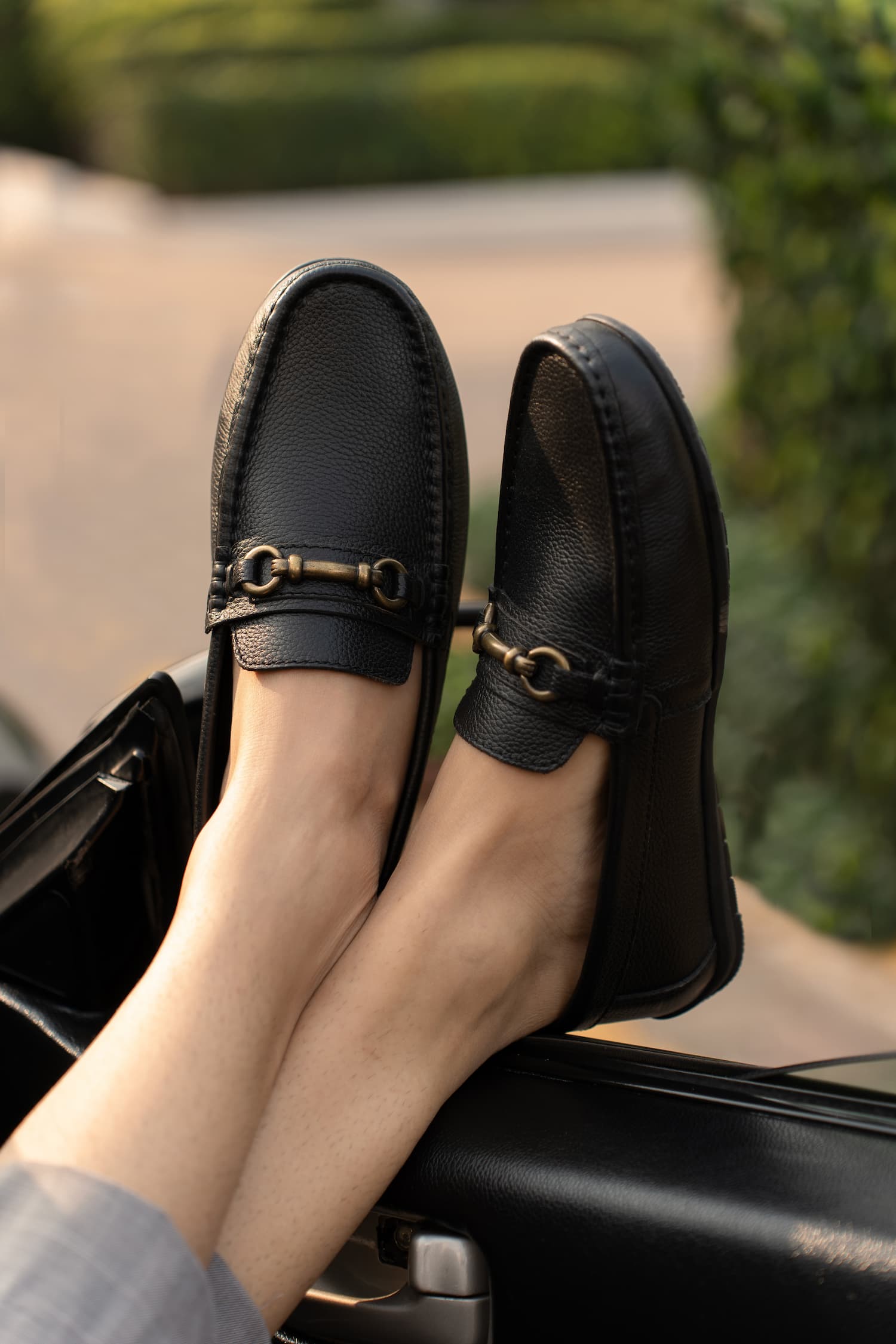 Mens Milled grain leather moccasins in black colour with metallic antique gold horsebit buckle by JULKE. 
