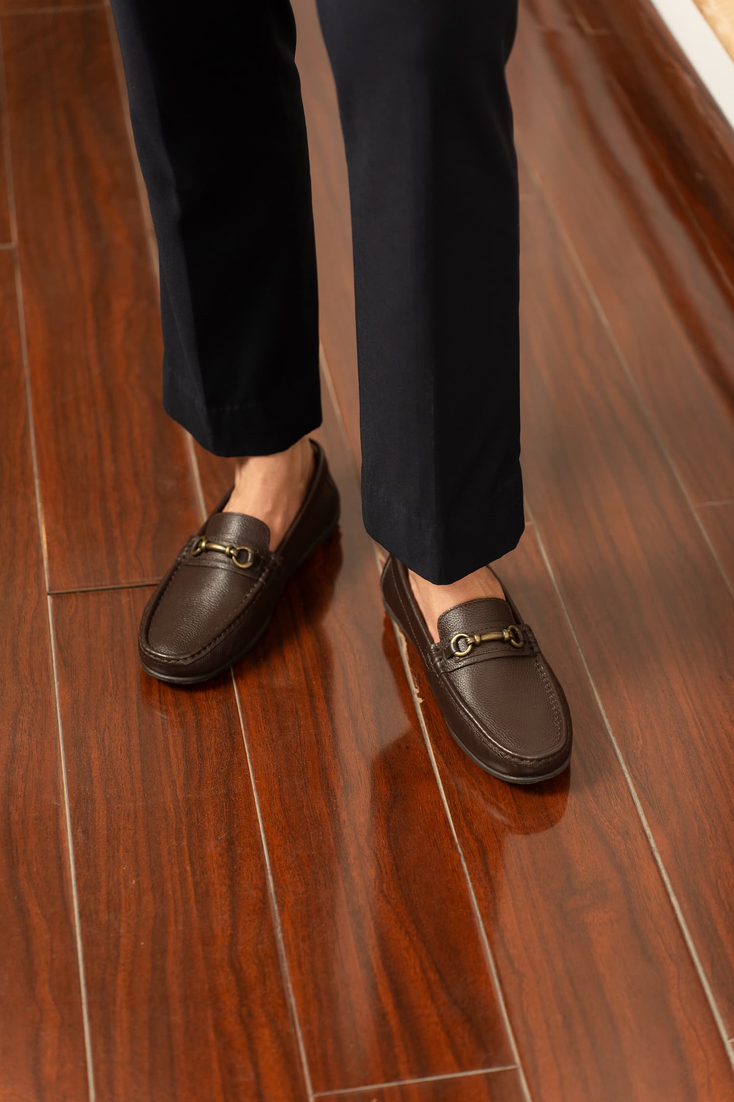 Mens Milled grain leather moccasins in dark brown colour with metallic antique gold horsebit buckle by JULKE. 