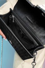 Women's suede leather clutch bag in shiny black colour with satin pleated flap and geometric transparent rhinestone brooch by JULKE.