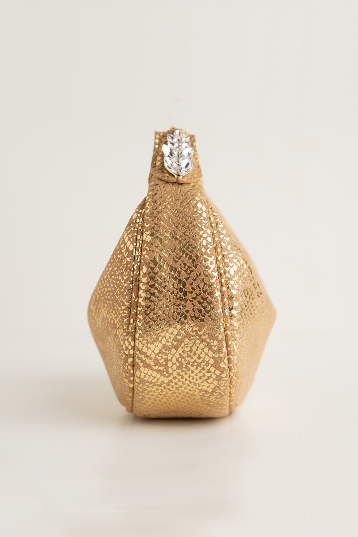 Women's leather mini halfmoon bag in gold colour with 3d reptile texture and unique clip-on handle by JULKE 