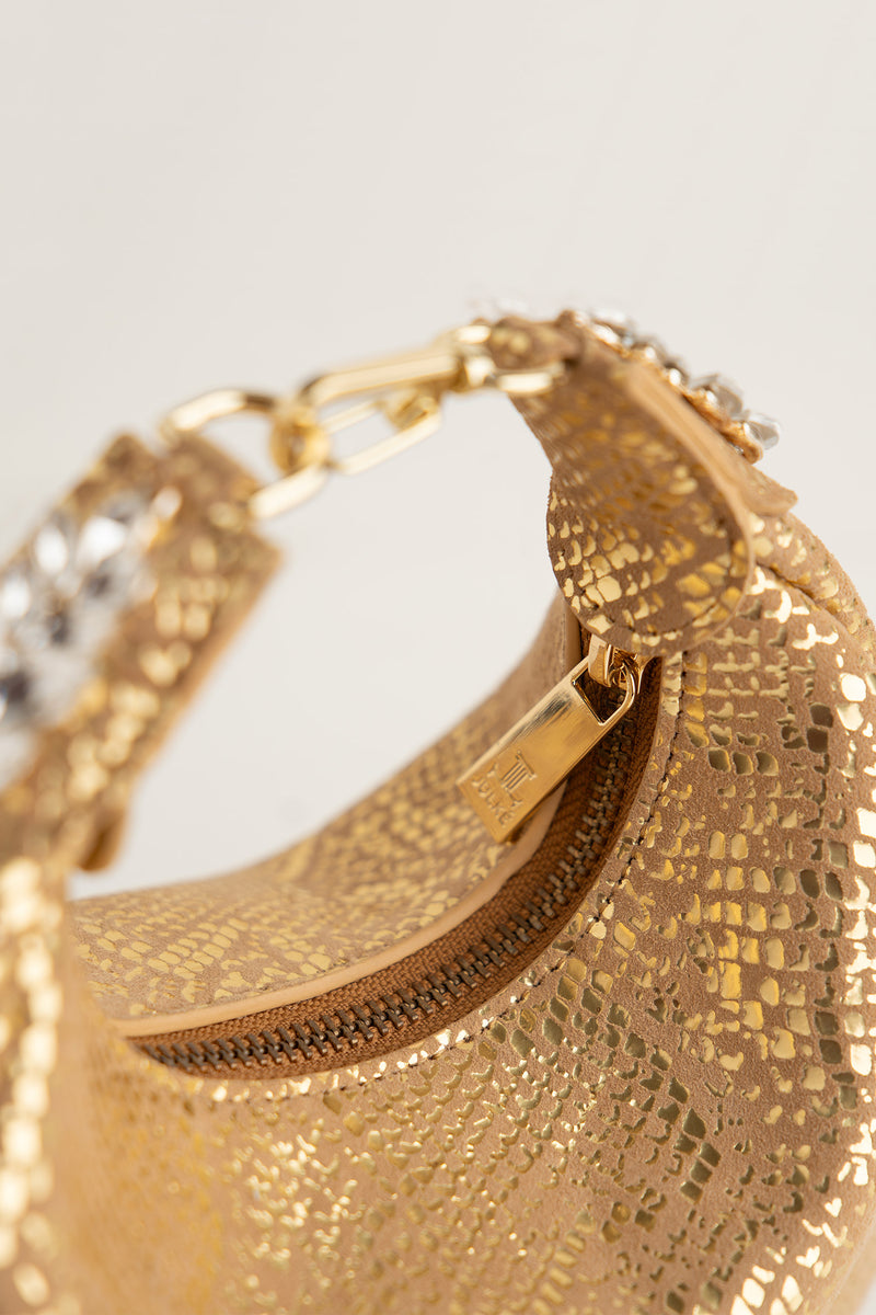 Women's leather mini halfmoon bag in gold colour with 3d reptile texture and unique clip-on handle by JULKE 
