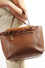 Womens soft leather shoulder bag in brown colour with top handle and weaving strap by JULKE