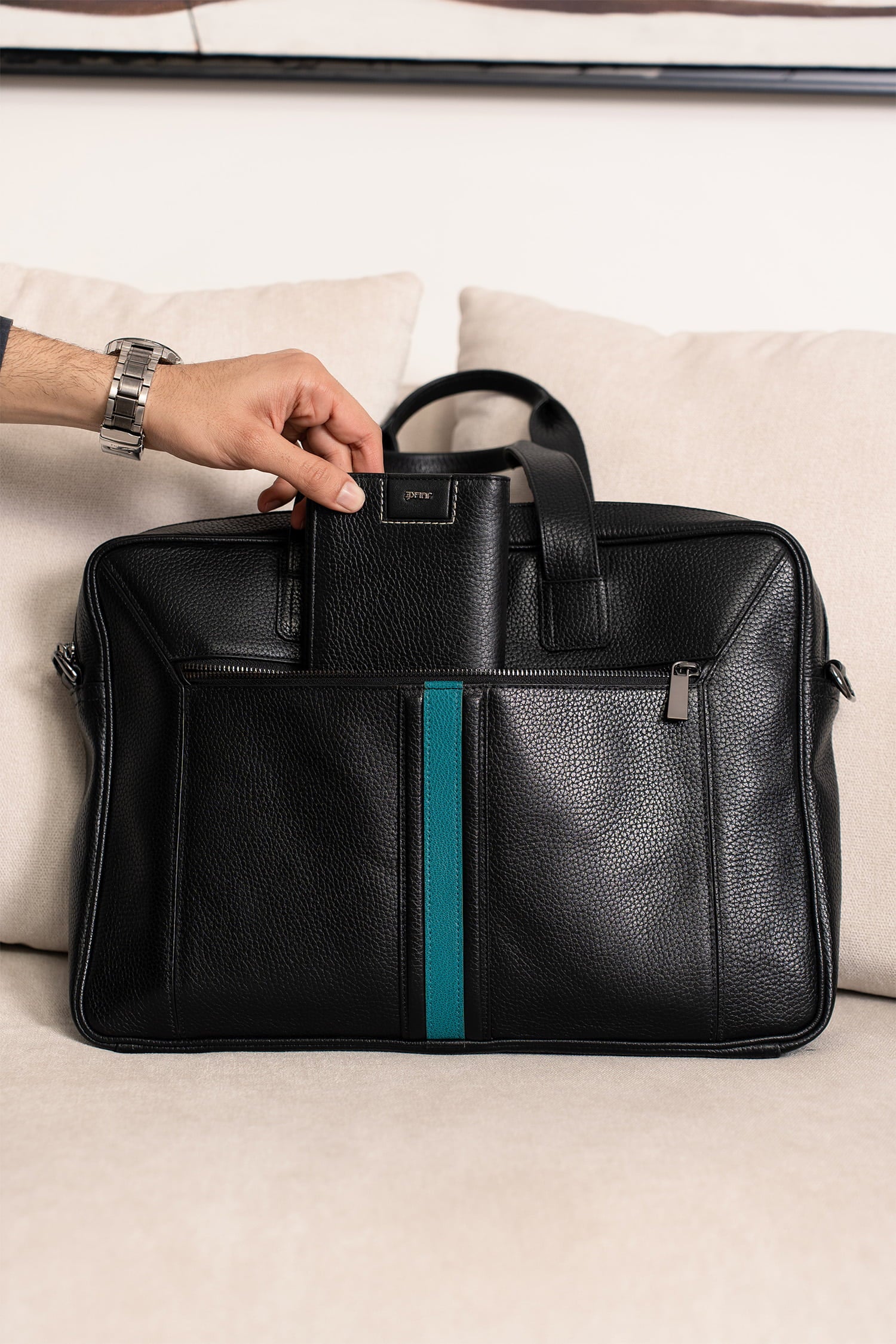 Mens soft leather laptop bag in black colour with turquoise leather stripe in front and metallic grey hardware by JULKE.